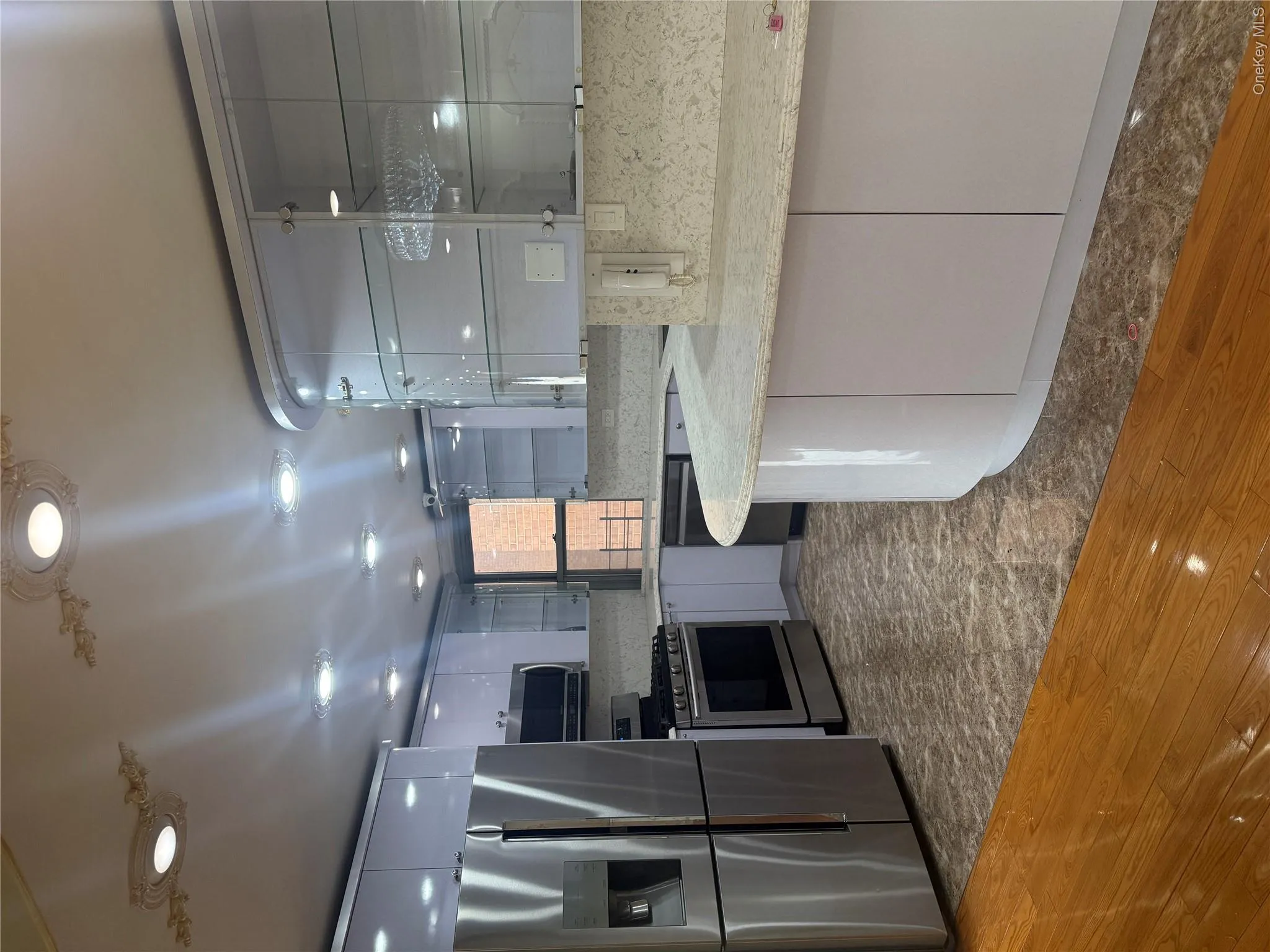 Kitchen featuring fridge, range, dishwashing machine, and modern cabinets Kitchen featuring fridge, range, dishwashing machine, and modern cabinets