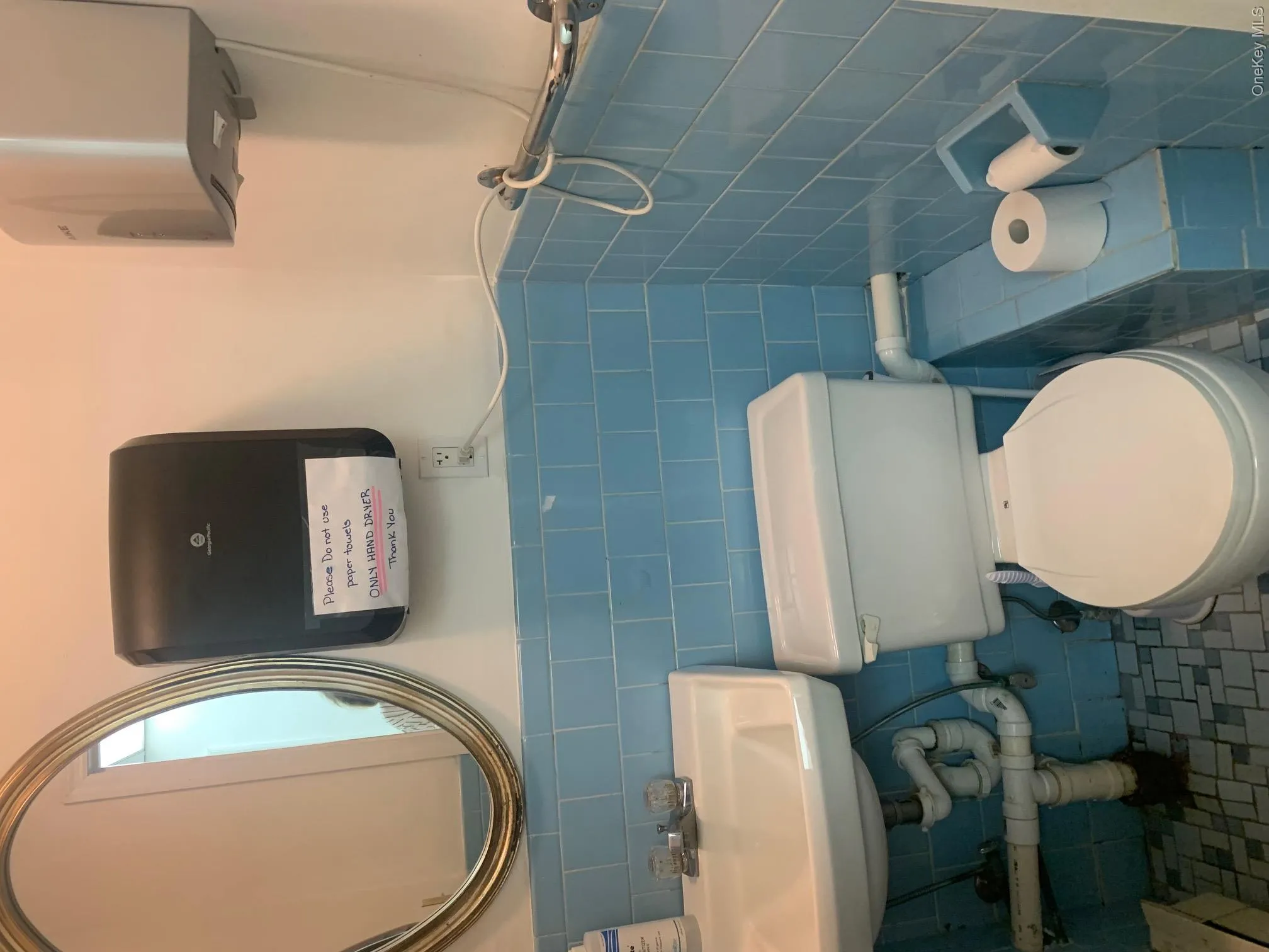 Half bath with tile walls, a wainscoted wall, and water UNIT 1 Half bath with tile walls, a wainscoted wall, and water UNIT 1