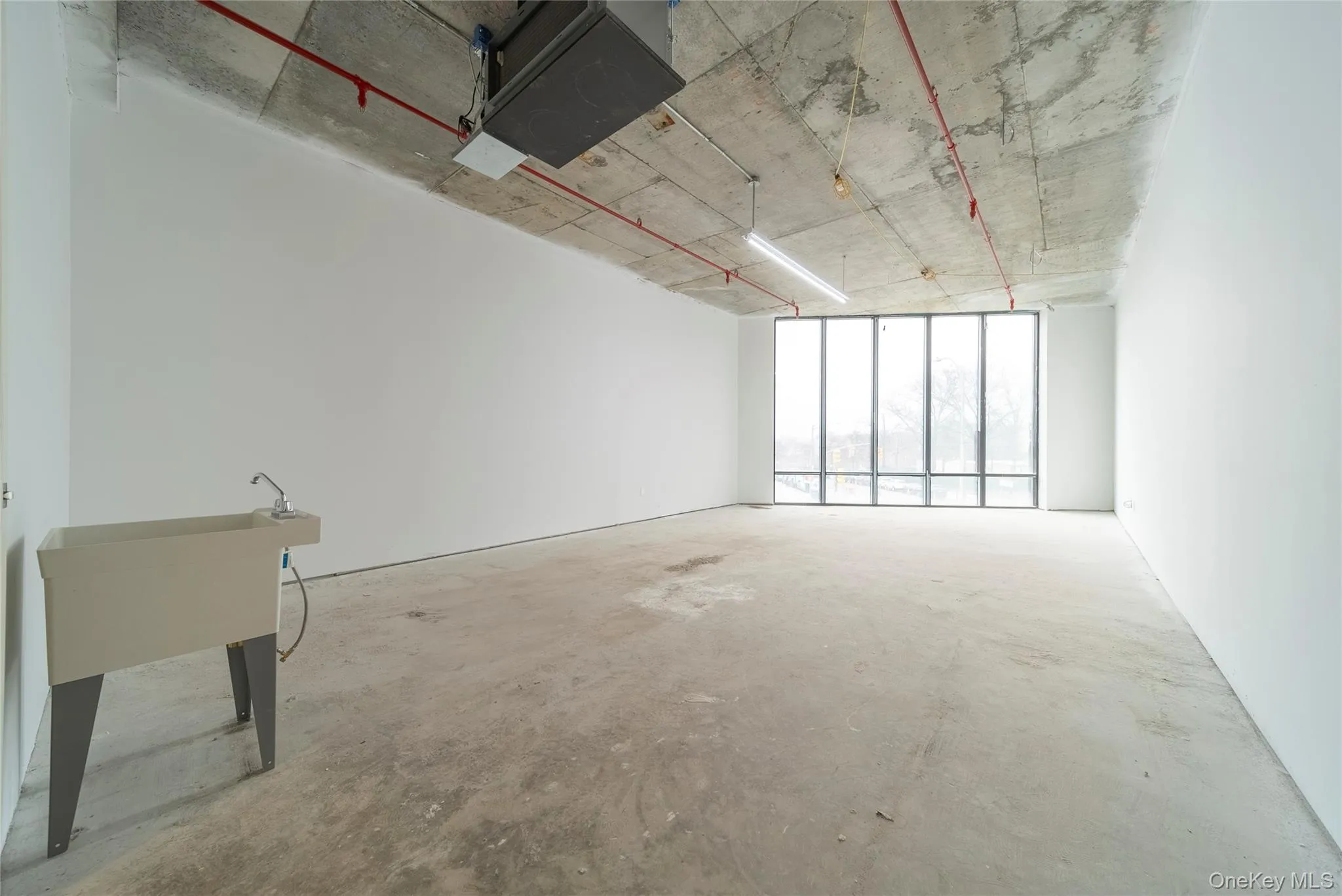 Unfurnished room featuring concrete floors Unfurnished room featuring concrete floors