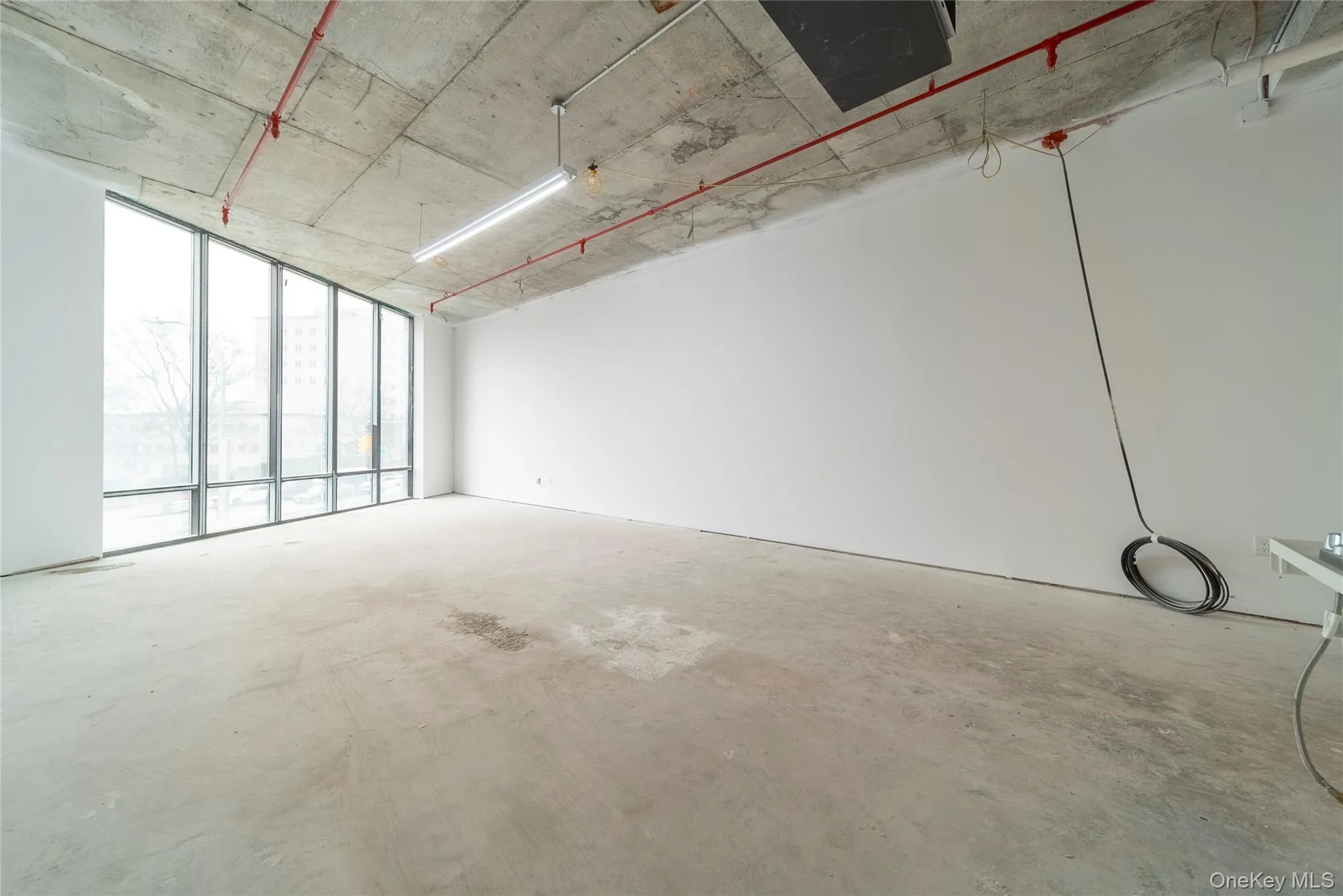 Empty room with concrete flooring Empty room with concrete flooring