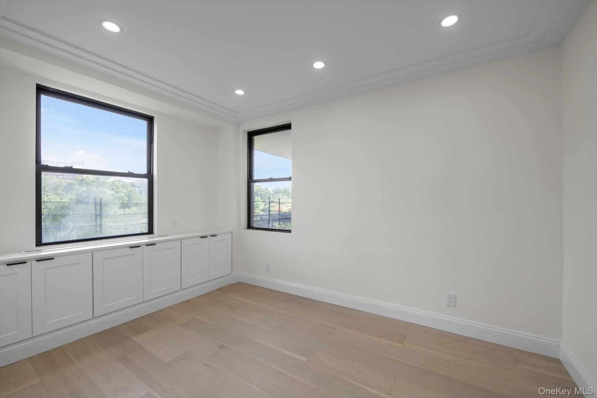 Unfurnished room featuring light wood finished floors and recessed lighting Unfurnished room featuring light wood finished floors and recessed lighting