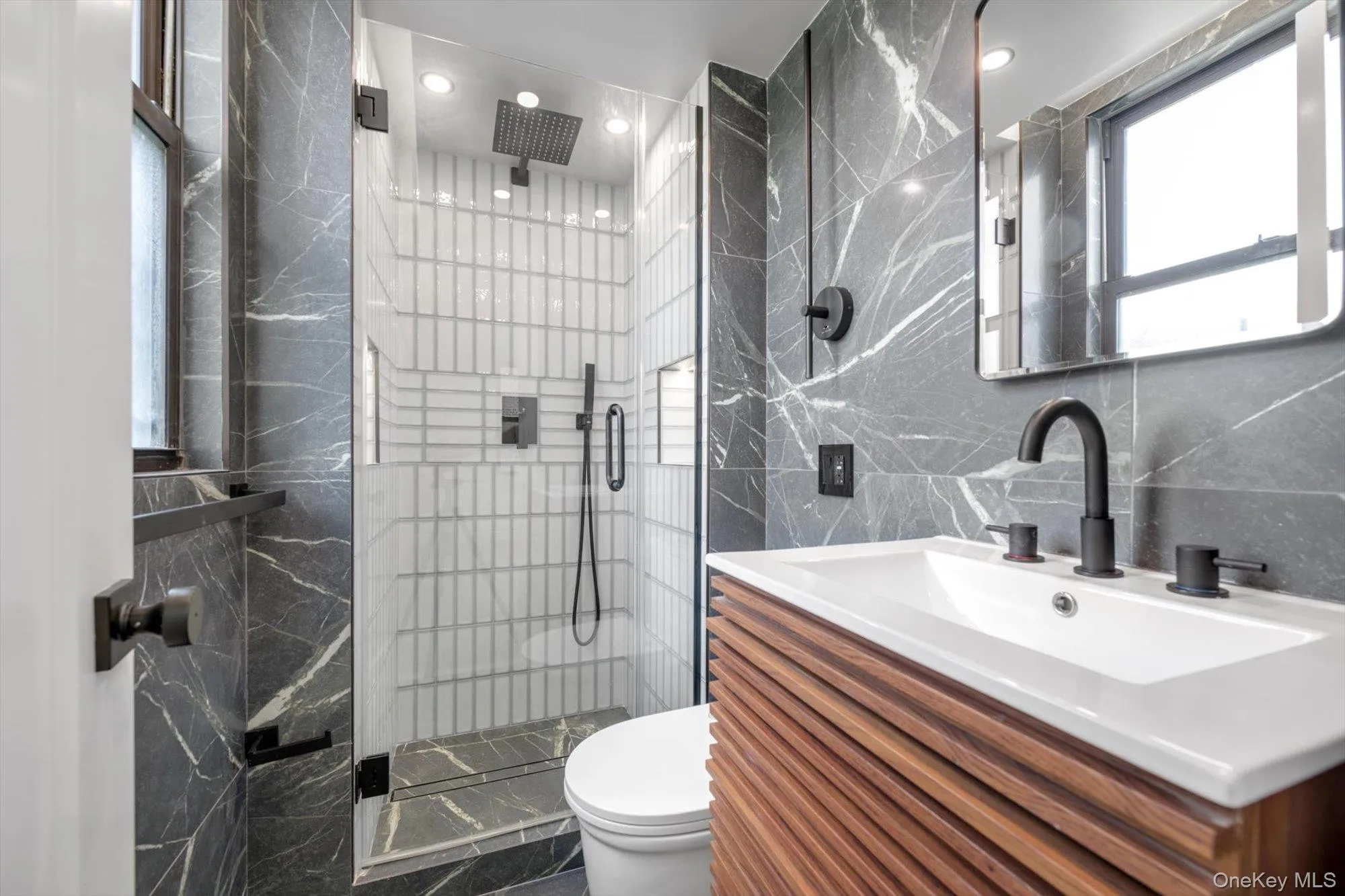 Full bath featuring tile walls, a shower stall, and vanity Full bath featuring tile walls, a shower stall, and vanity