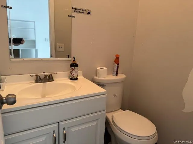 Half bathroom with toilet and vanity Half bathroom with toilet and vanity