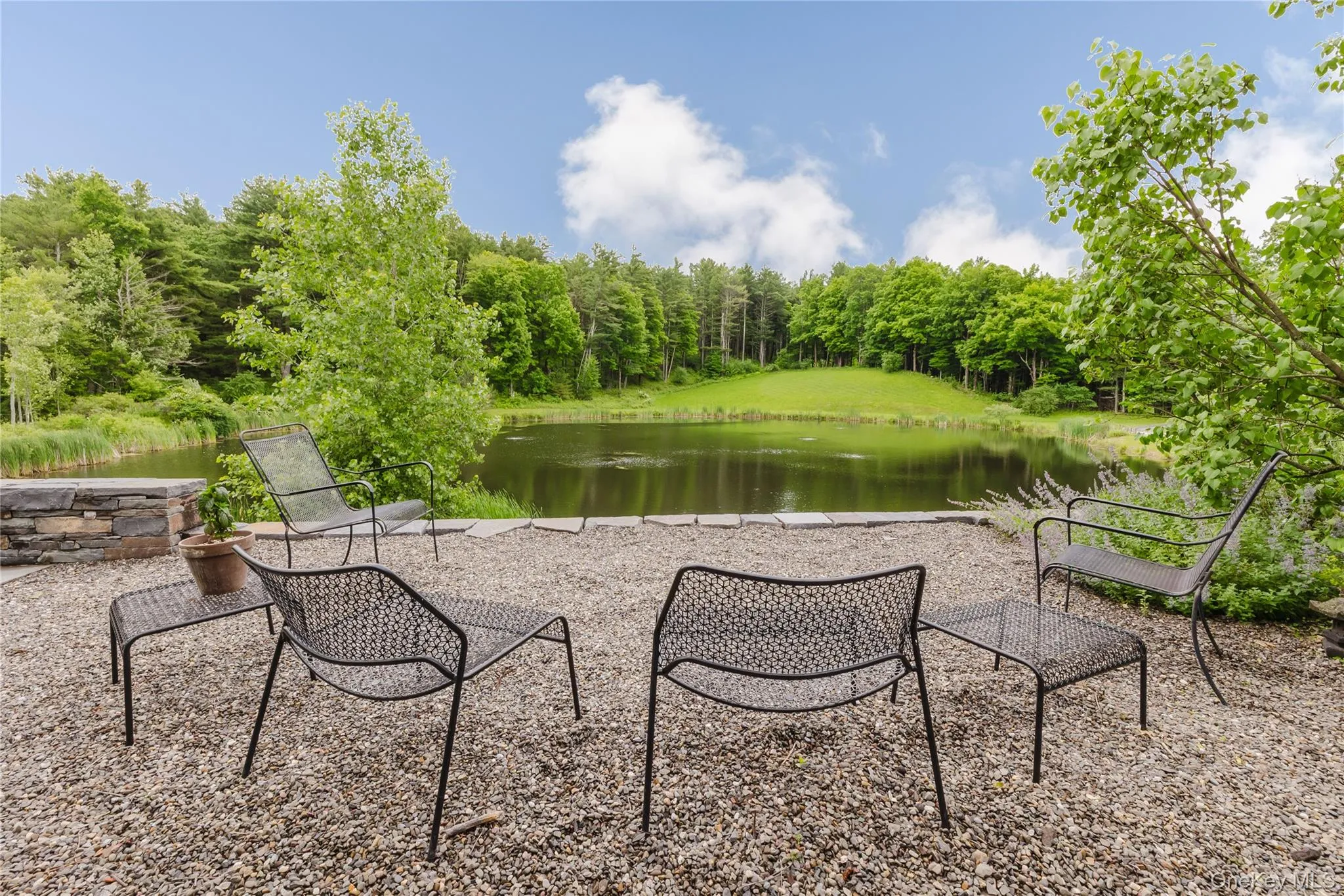 View of patio / terrace featuring a water view and a forest view View of patio / terrace featuring a water view and a forest view