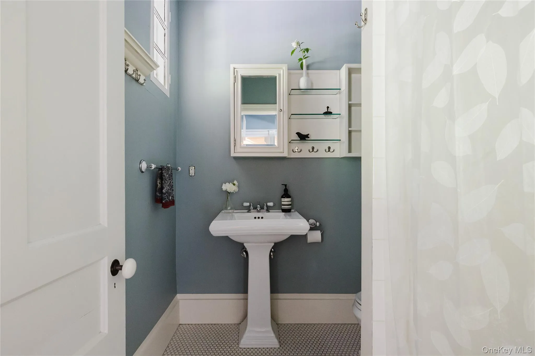 Bathroom featuring tile patterned floors and a shower with curtain Bathroom featuring tile patterned floors and a shower with curtain