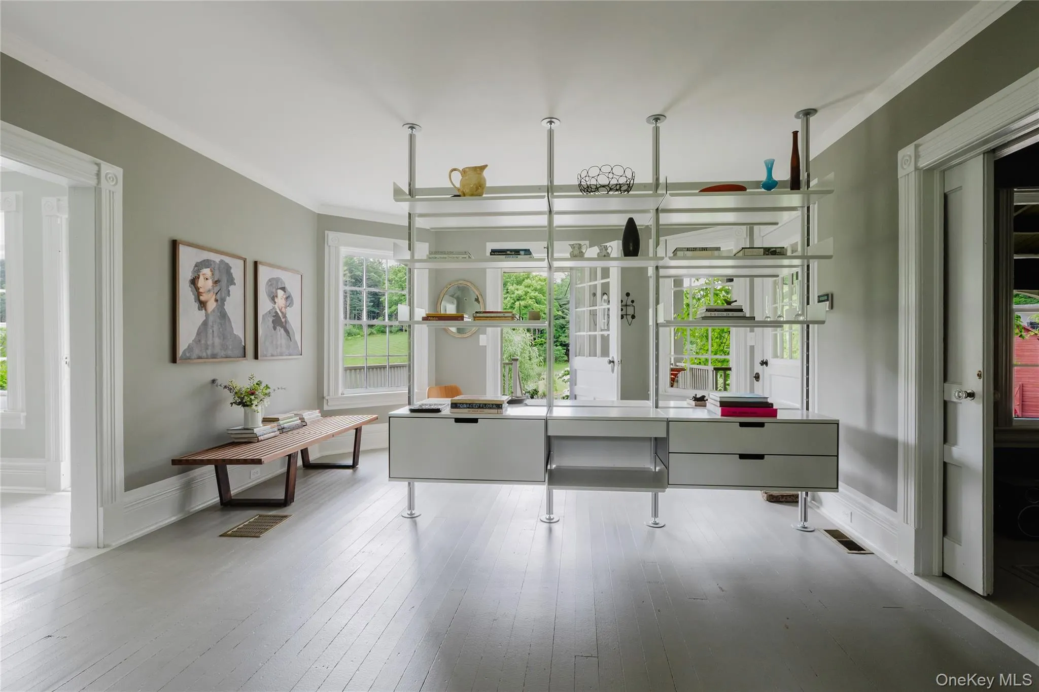 Home office with ornamental molding, wood finished floors, a wainscoted wall, and a decorative wall Home office with ornamental molding, wood finished floors, a wainscoted wall, and a decorative wall