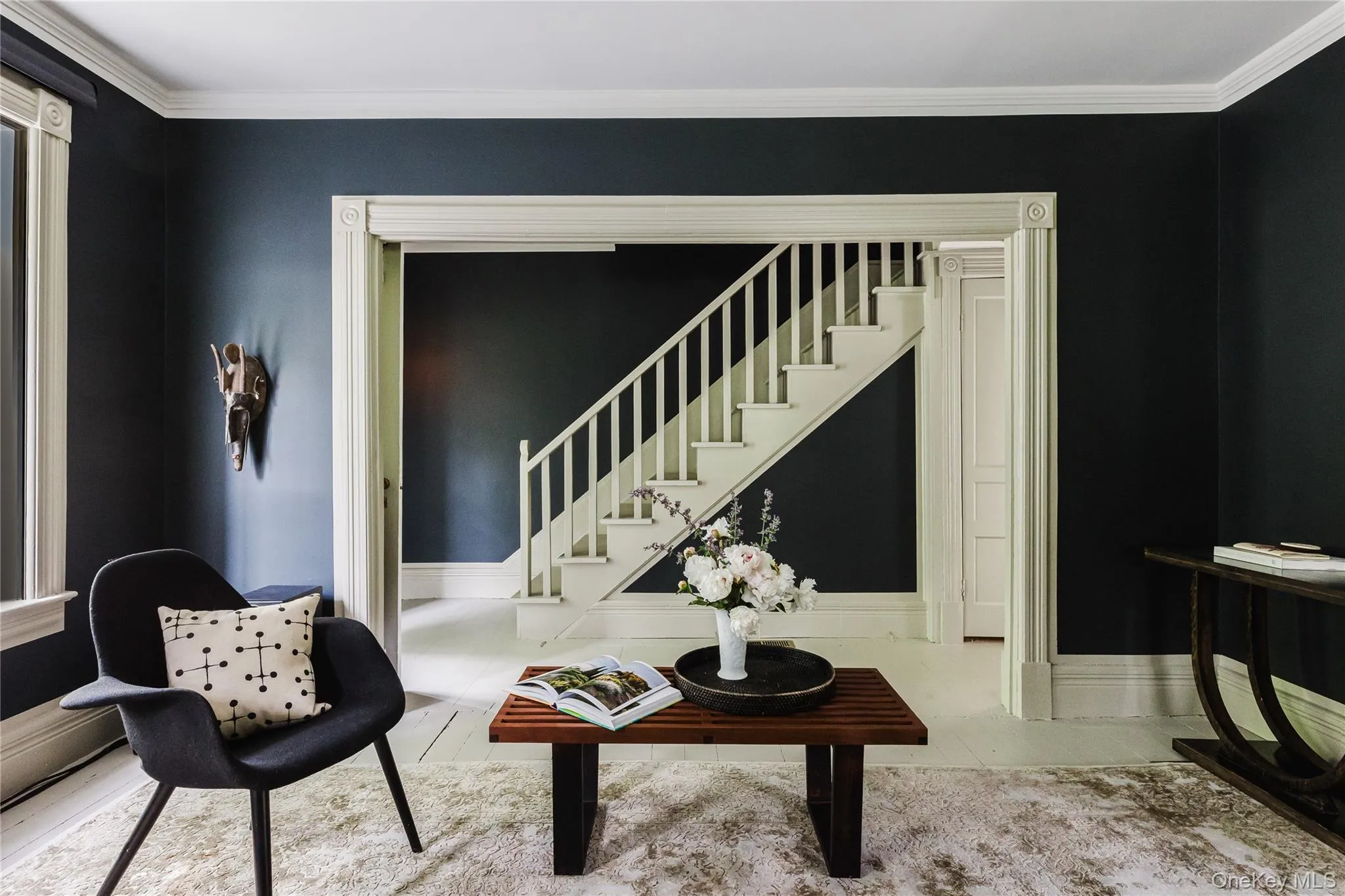 Living room with stairs and crown molding Living room with stairs and crown molding