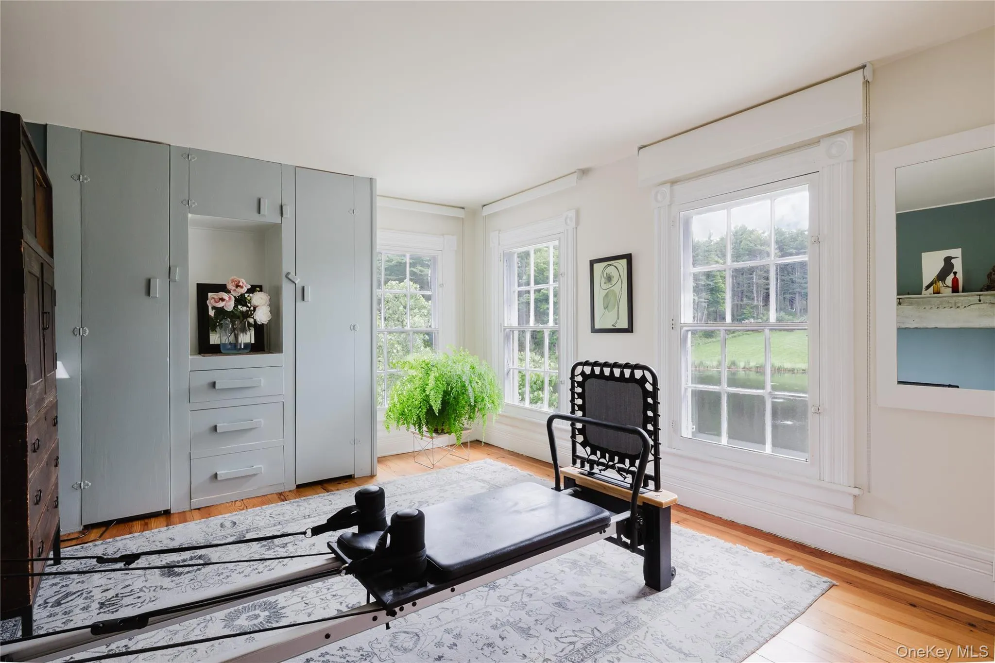 Workout area with light wood-style floors and baseboards Workout area with light wood-style floors and baseboards