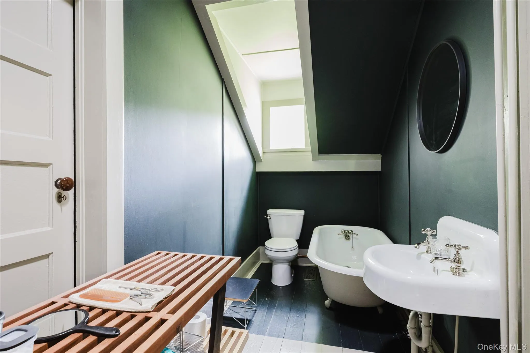 Full bath featuring a freestanding tub and wood finished floors Full bath featuring a freestanding tub and wood finished floors