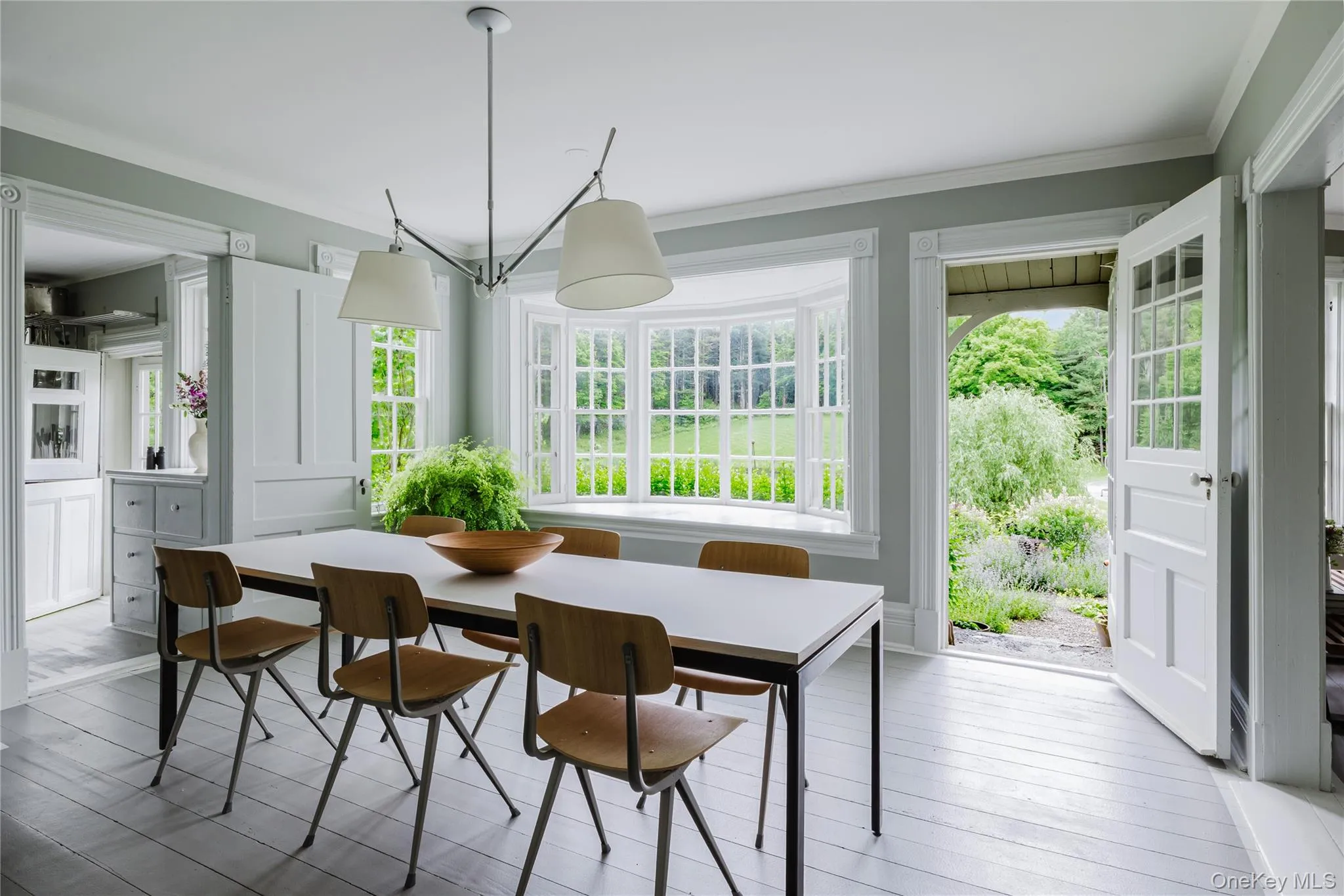 Dining area featuring ornamental molding and wood finished floors Dining area featuring ornamental molding and wood finished floors