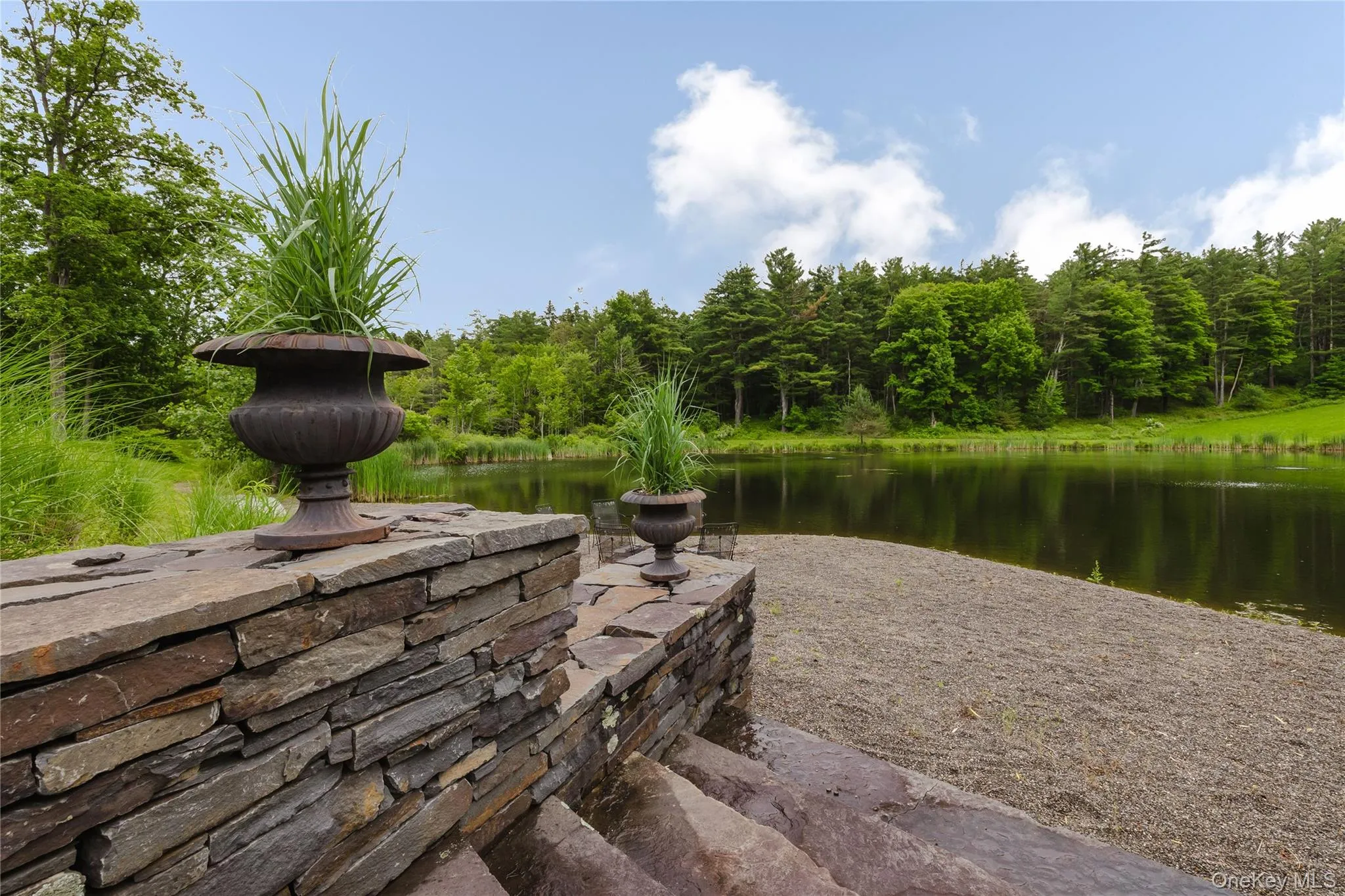 Dock area featuring a water view and a wooded view Dock area featuring a water view and a wooded view