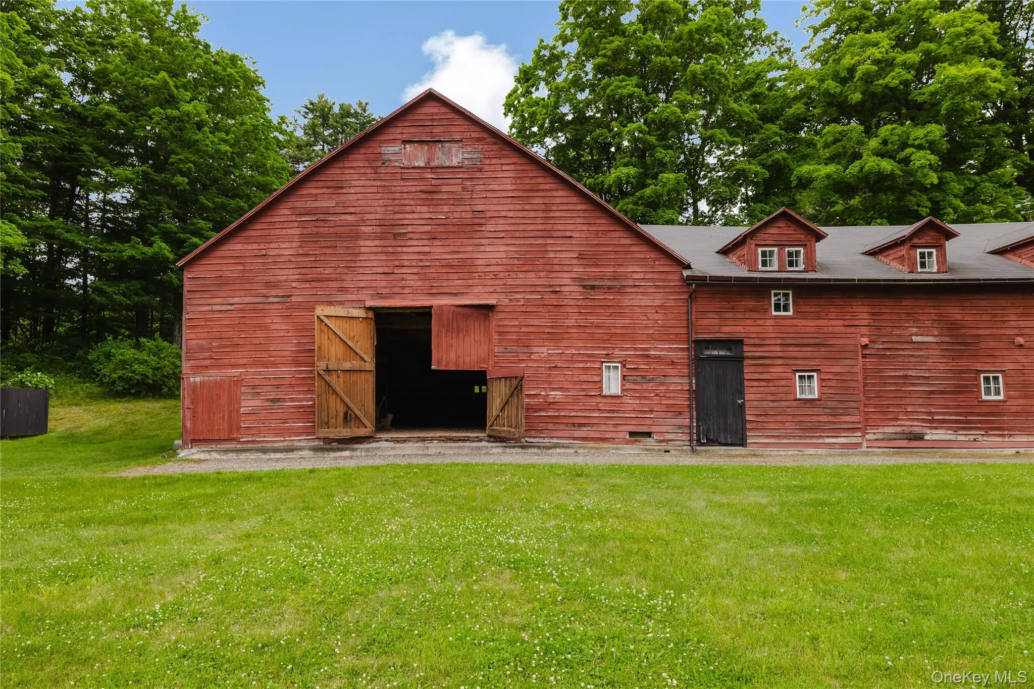 Back of property featuring a barn, a yard, and an outdoor structure Back of property featuring a barn, a yard, and an outdoor structure