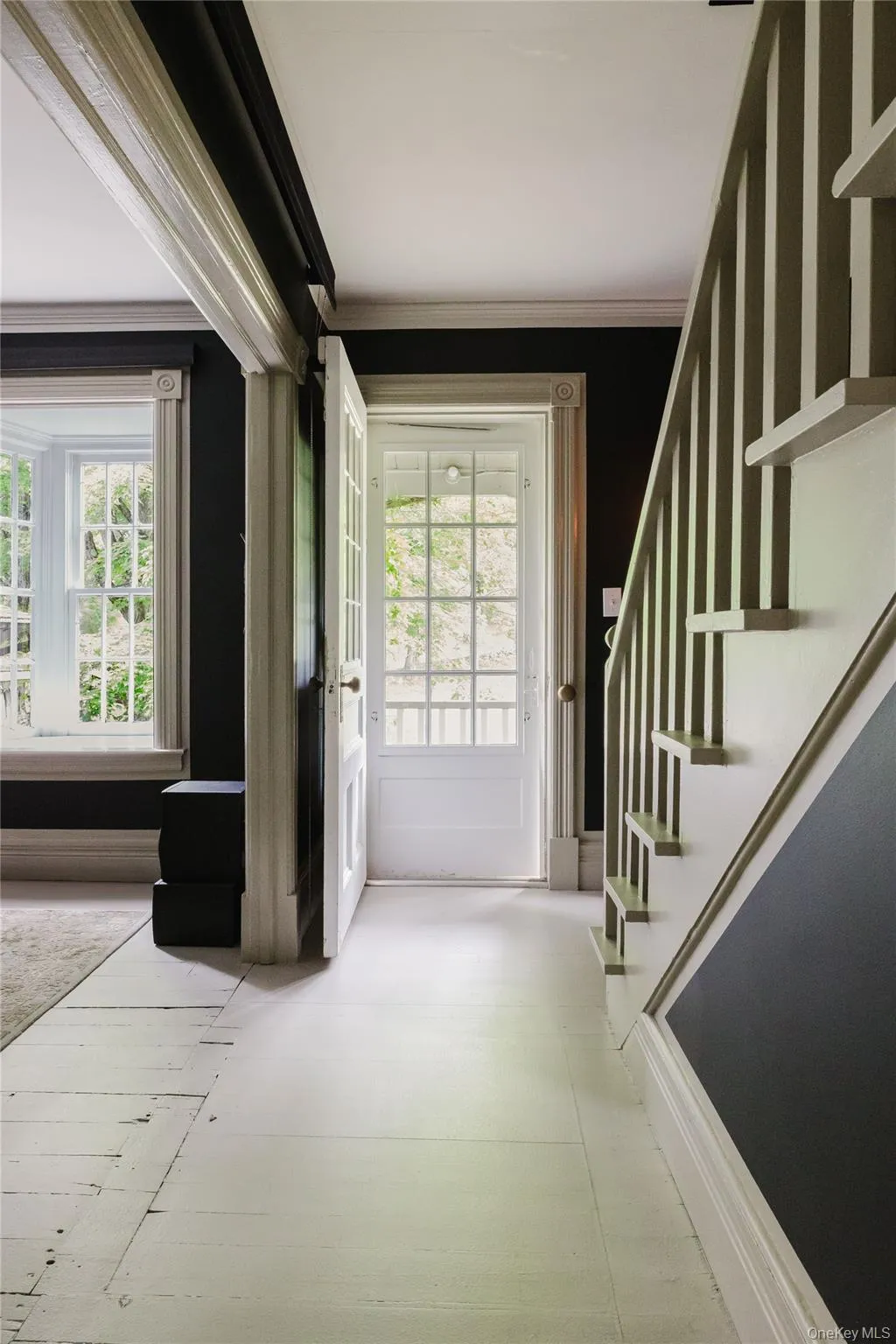 Entrance foyer with stairs, plenty of natural light, and crown molding Entrance foyer with stairs, plenty of natural light, and crown molding