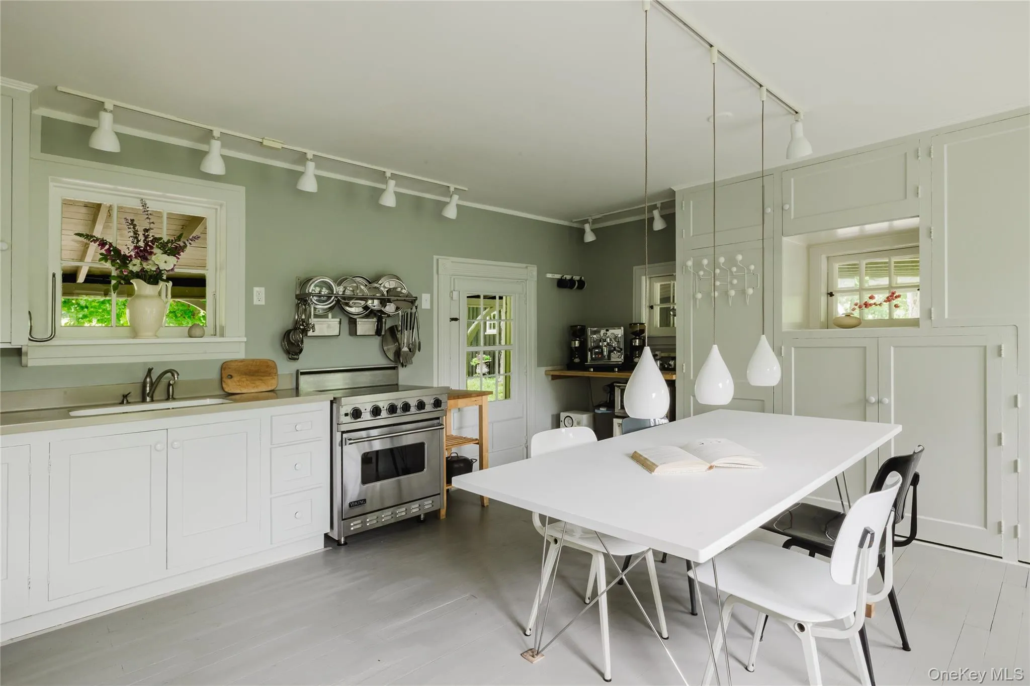 Dining space with track lighting and light wood-style flooring Dining space with track lighting and light wood-style flooring