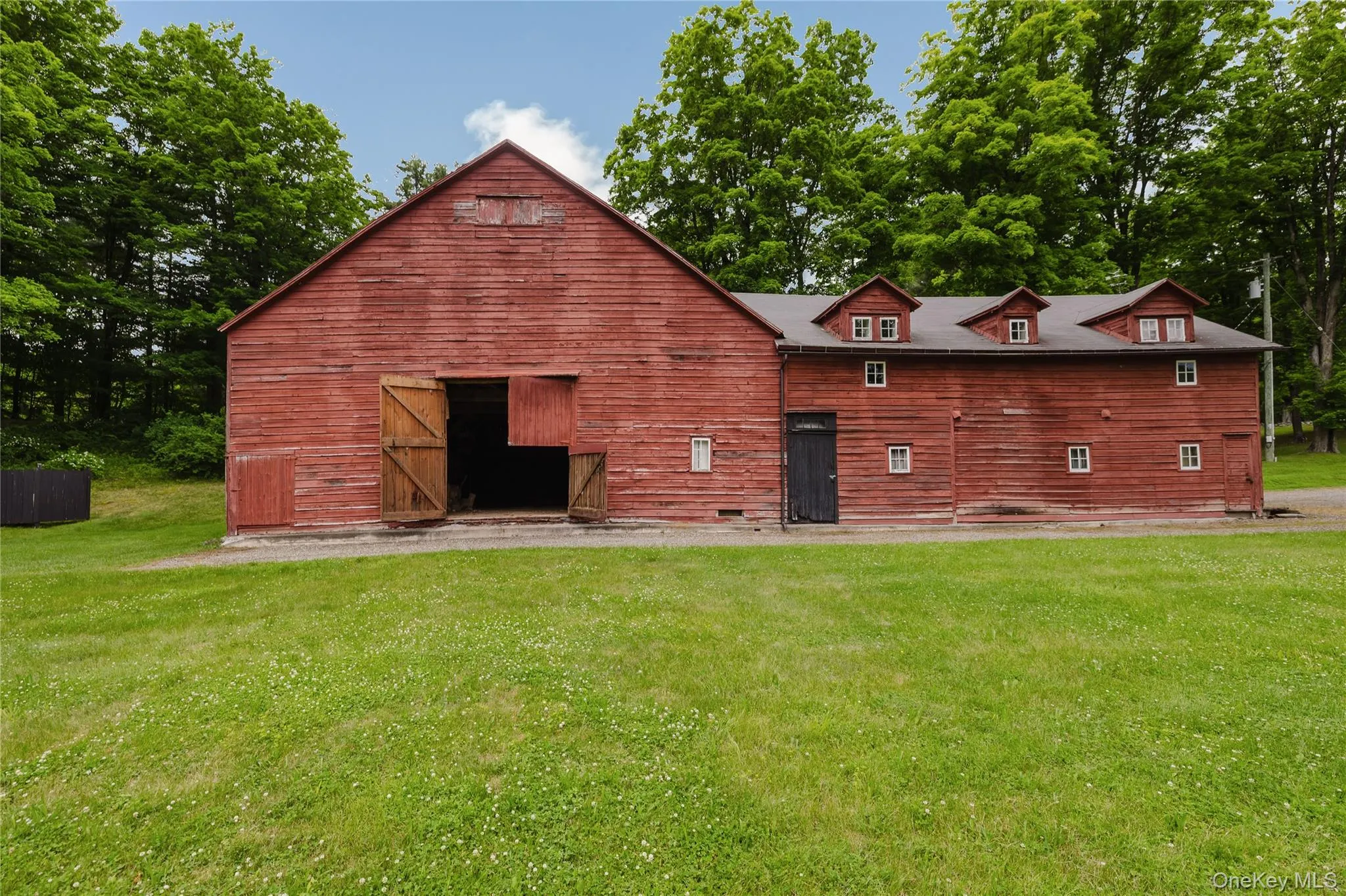 Rear view of house featuring a barn, a yard, and an outbuilding Rear view of house featuring a barn, a yard, and an outbuilding