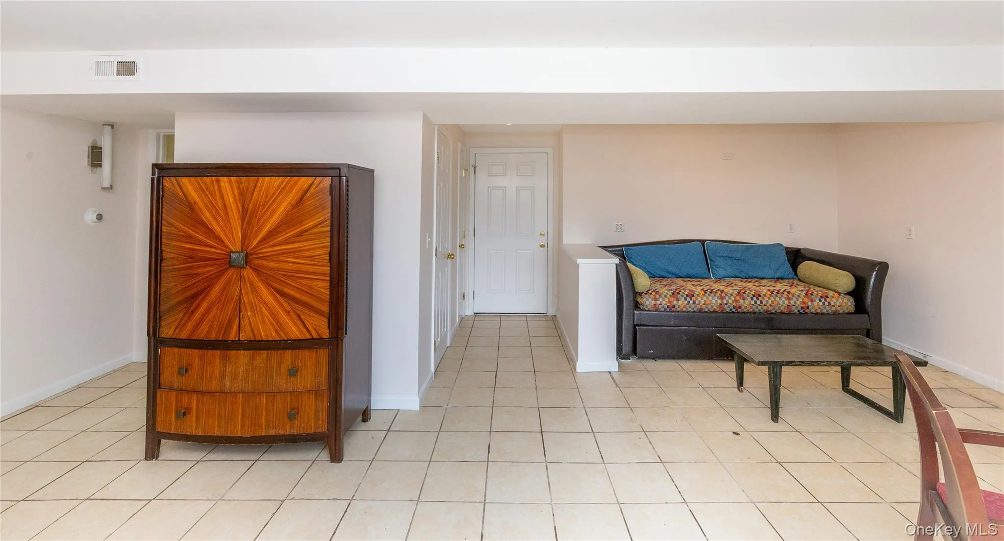 The door in the center leads to the stairs upstairs on the left and to the right, the washer, dryer, and second refrigerator. The door in the center leads to the stairs upstairs on the left and to the right, the washer, dryer, and second refrigerator.