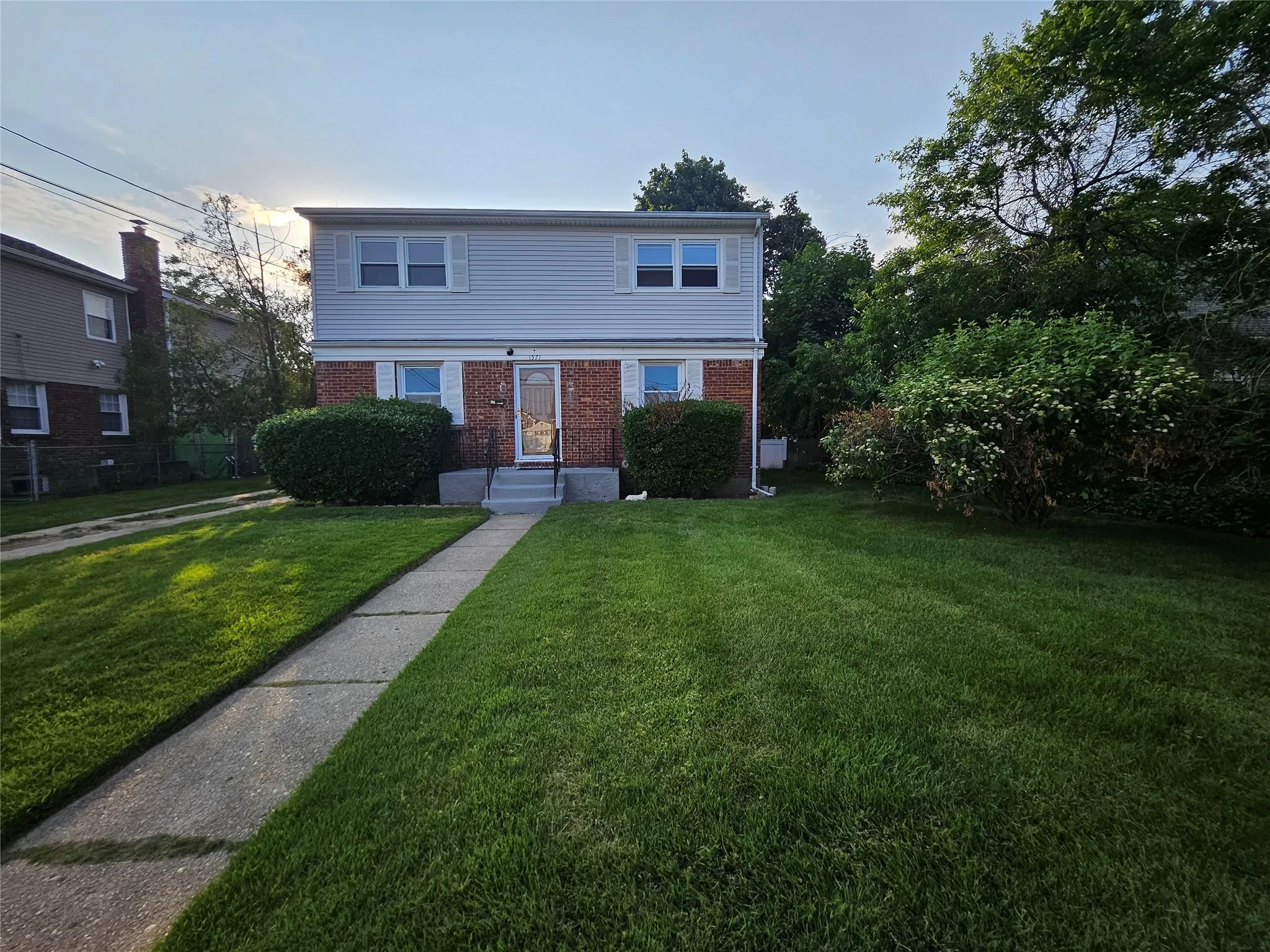 View of front facade with brick siding and a front lawn View of front facade with brick siding and a front lawn