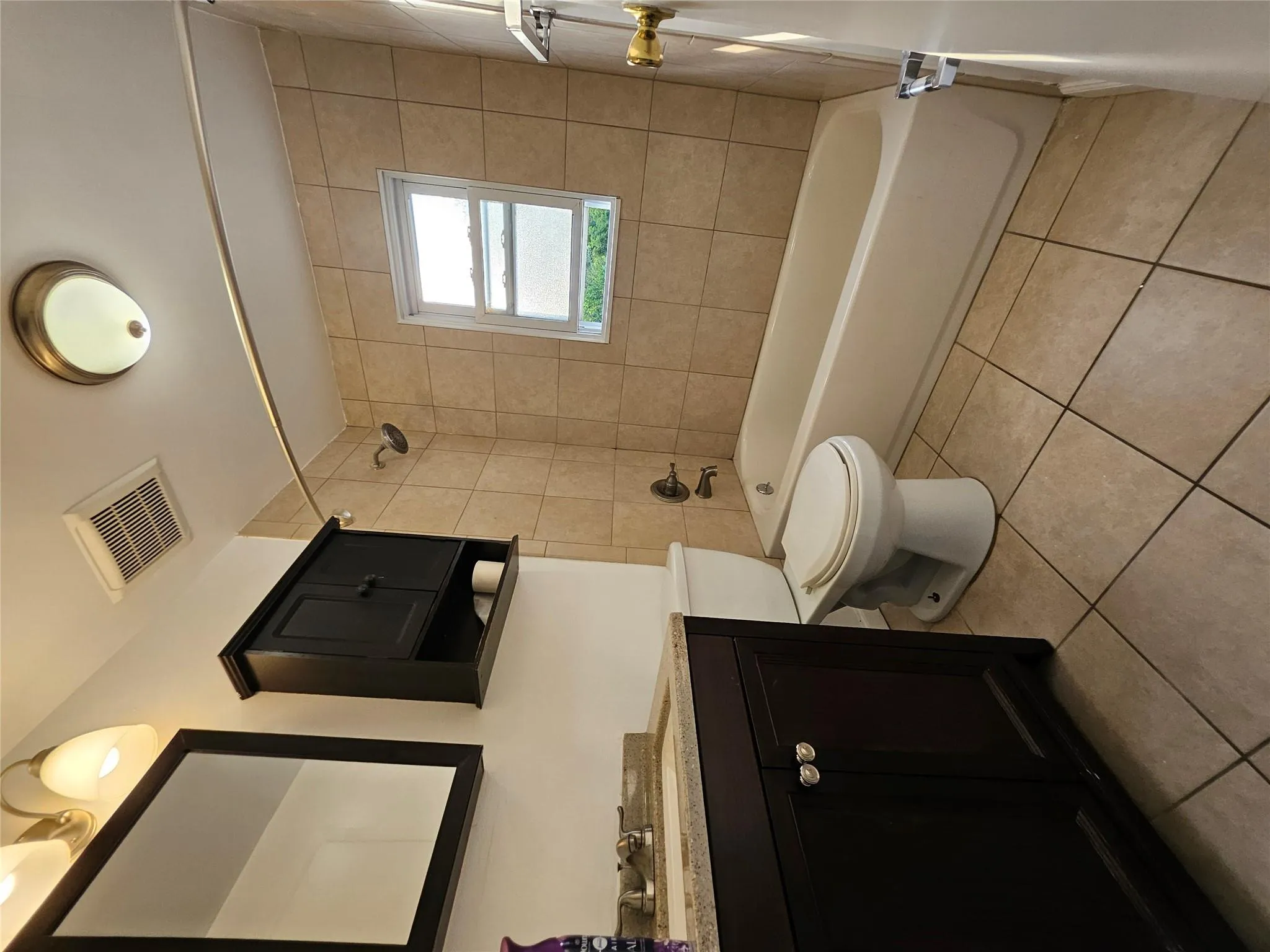 Full bathroom featuring vanity, tile patterned flooring, and shower / bathtub combination Full bathroom featuring vanity, tile patterned flooring, and shower / bathtub combination