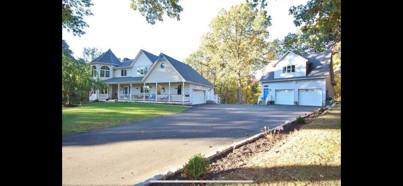 View of front of house with covered porch, a front lawn, asphalt driveway, and an attached garage View of front of house with covered porch, a front lawn, asphalt driveway, and an attached garage