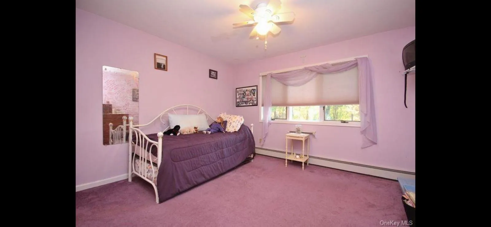Carpeted bedroom with a baseboard heating unit and ceiling fan Carpeted bedroom with a baseboard heating unit and ceiling fan