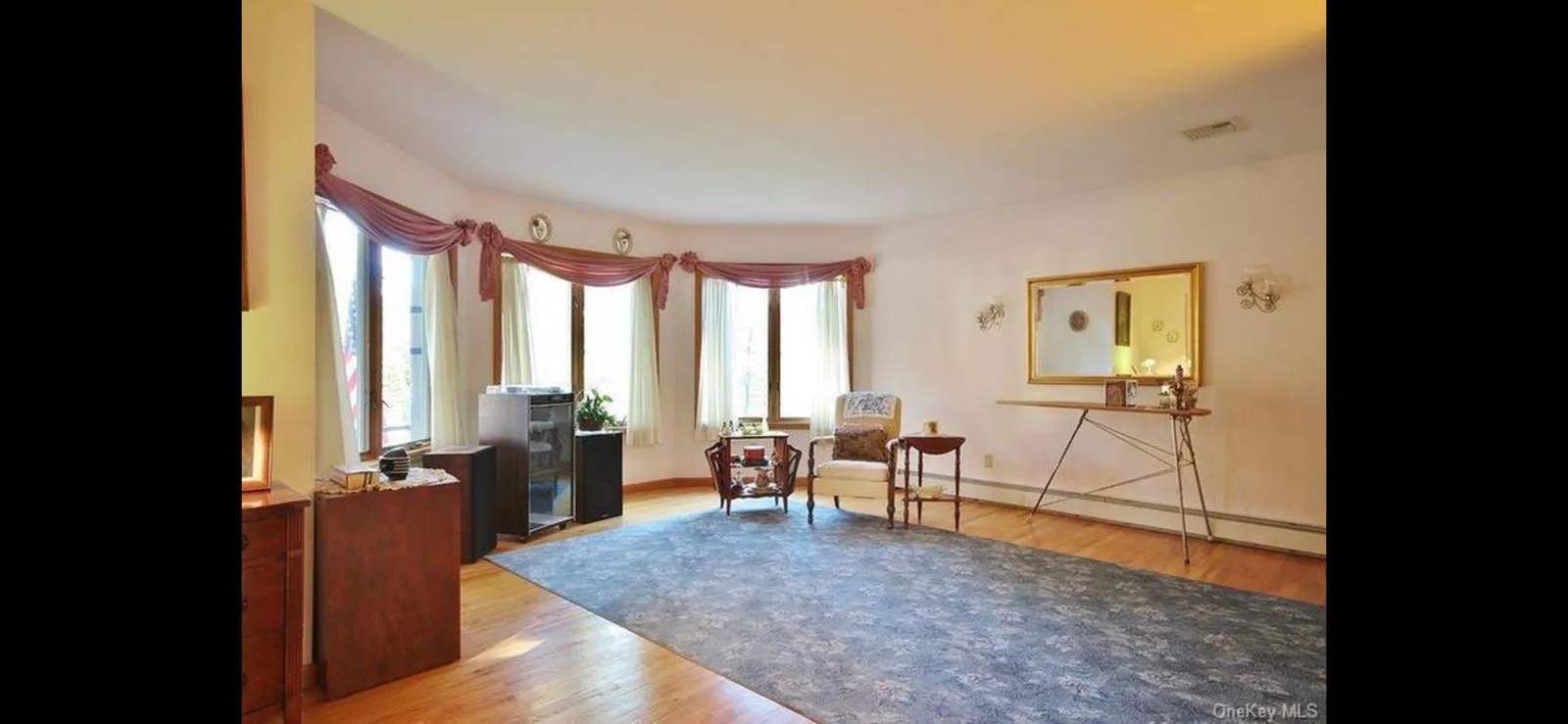 Sitting room featuring light wood-style floors and a baseboard heating unit Sitting room featuring light wood-style floors and a baseboard heating unit