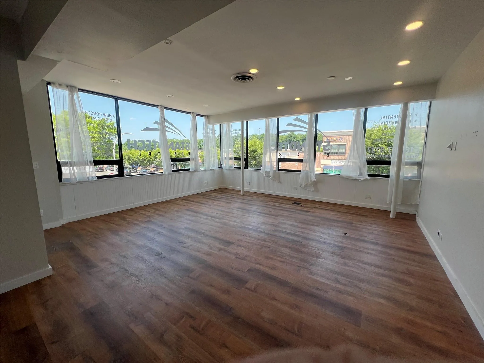 Unfurnished sunroom with wood finished floors and recessed lighting Unfurnished sunroom with wood finished floors and recessed lighting