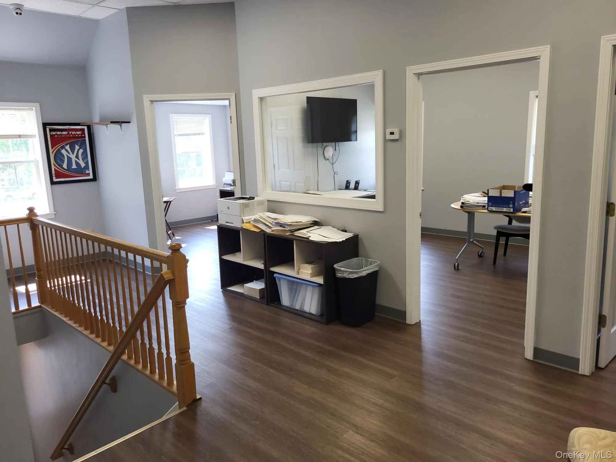 Corridor featuring an upstairs landing, dark wood-style flooring, and an office area Corridor featuring an upstairs landing, dark wood-style flooring, and an office area