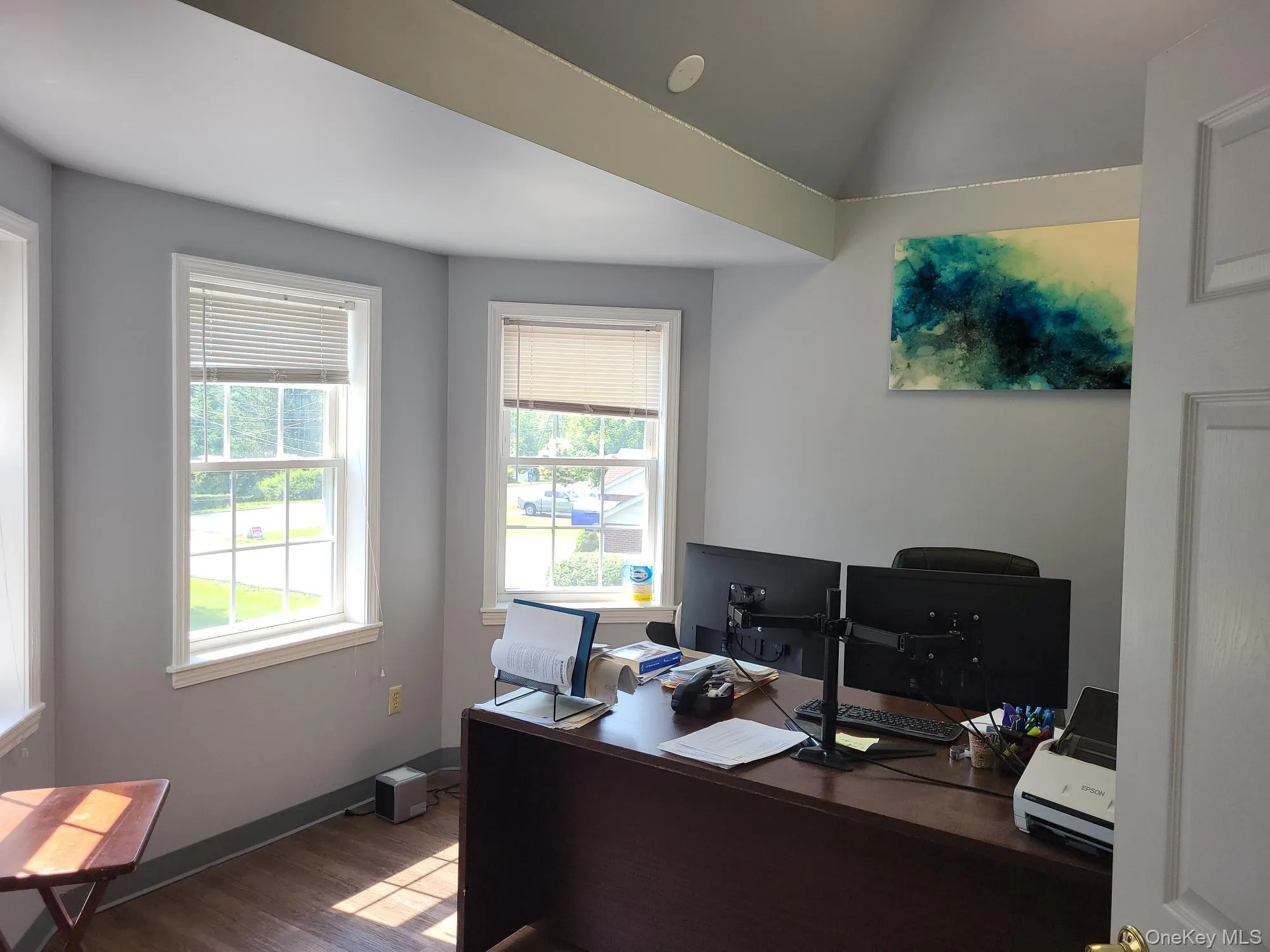 Office area with wood finished floors and lofted ceiling Office area with wood finished floors and lofted ceiling