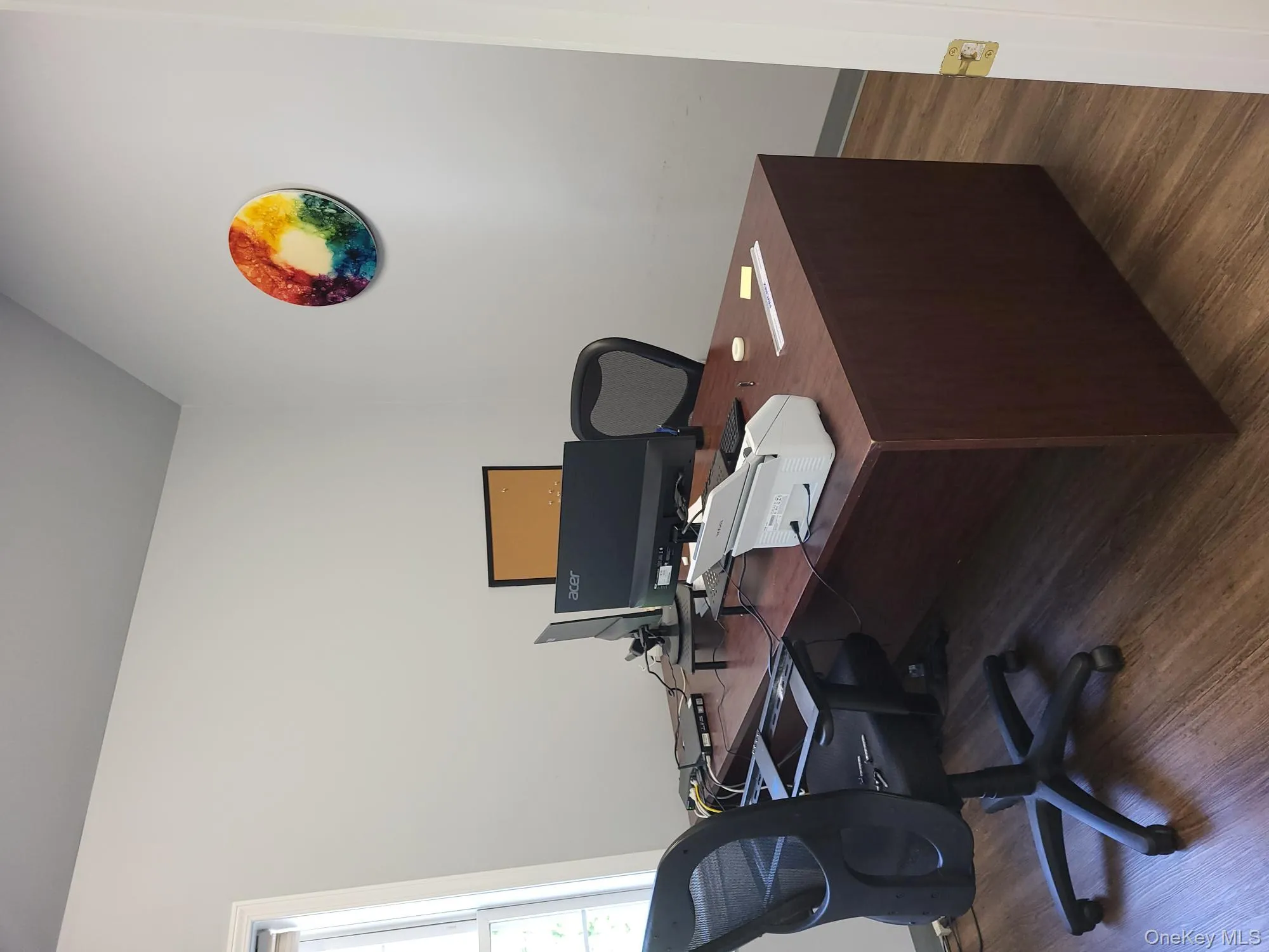 Office area with wood finished floors and vaulted ceiling Office area with wood finished floors and vaulted ceiling