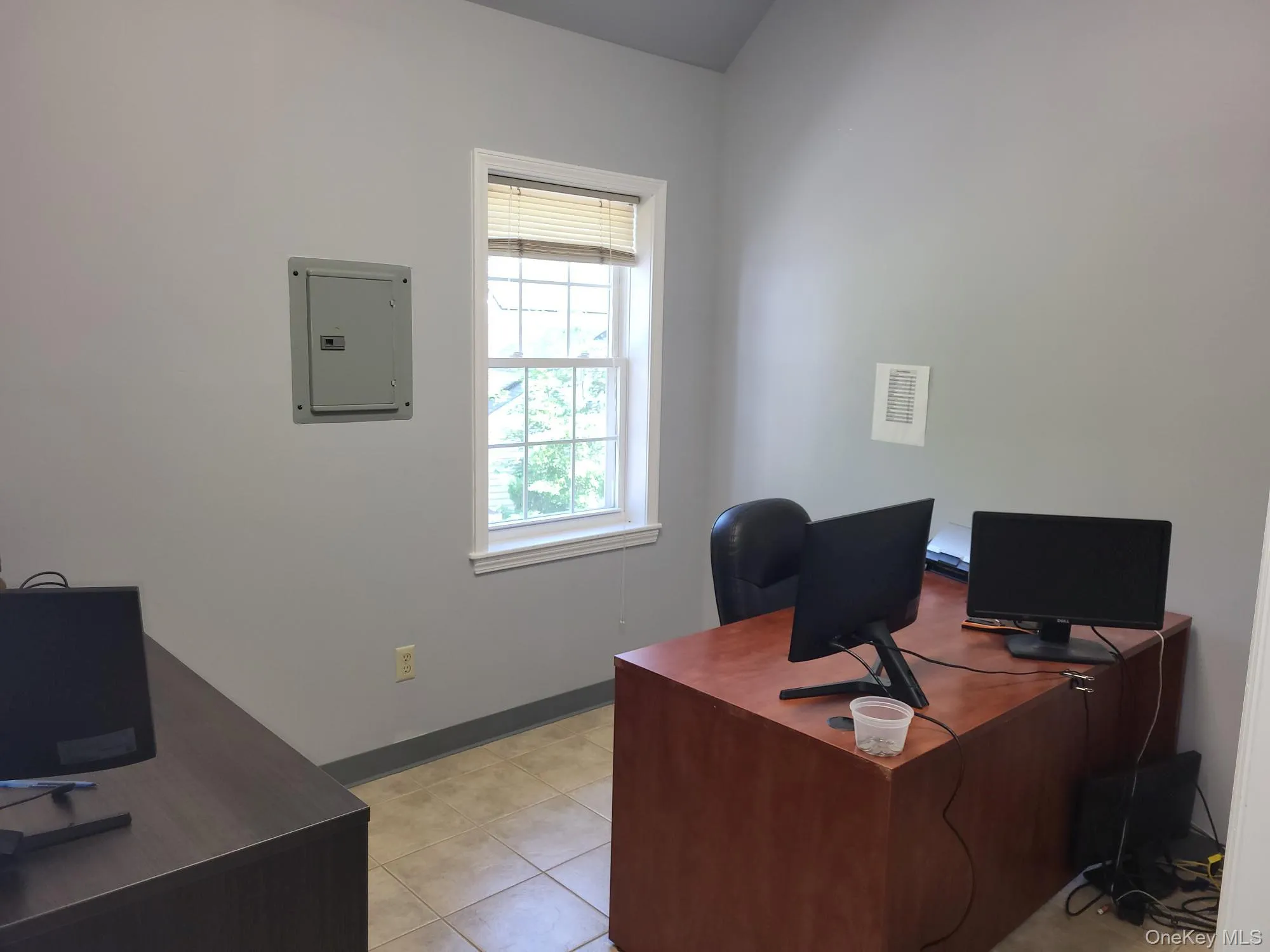 Office area with electric panel and light tile patterned floors Office area with electric panel and light tile patterned floors