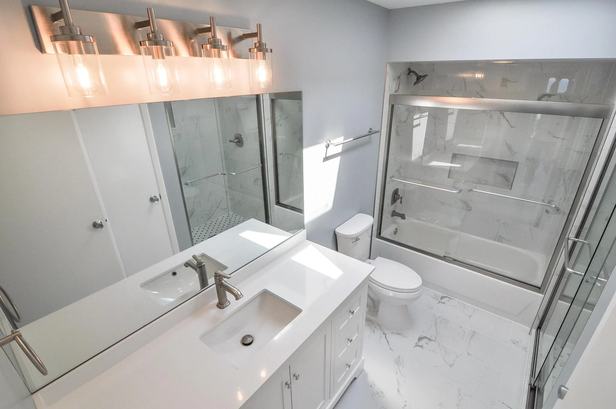 Full bath with vanity, marble finish floors, and enclosed tub / shower combo Full bath with vanity, marble finish floors, and enclosed tub / shower combo
