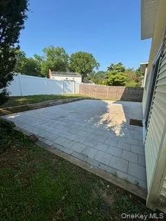 Fenced backyard featuring a patio area Fenced backyard featuring a patio area