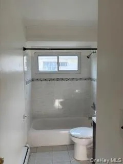 Bathroom with tile patterned floors, vanity, and tub / shower combination Bathroom with tile patterned floors, vanity, and tub / shower combination