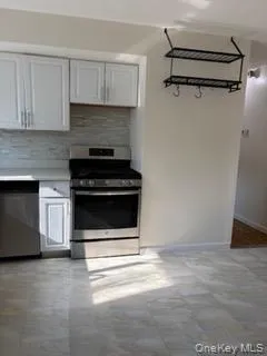 Kitchen featuring appliances with stainless steel finishes, light countertops, and tasteful backsplash Kitchen featuring appliances with stainless steel finishes, light countertops, and tasteful backsplash