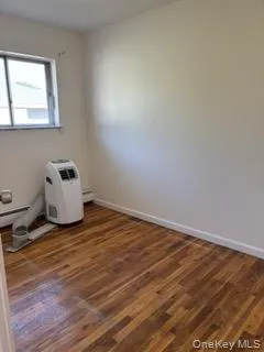 Empty room with wood finished floors and baseboards Empty room with wood finished floors and baseboards