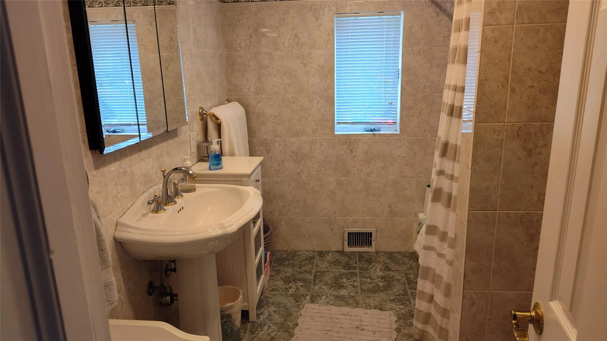 Bathroom featuring a shower with shower curtain Bathroom featuring a shower with shower curtain