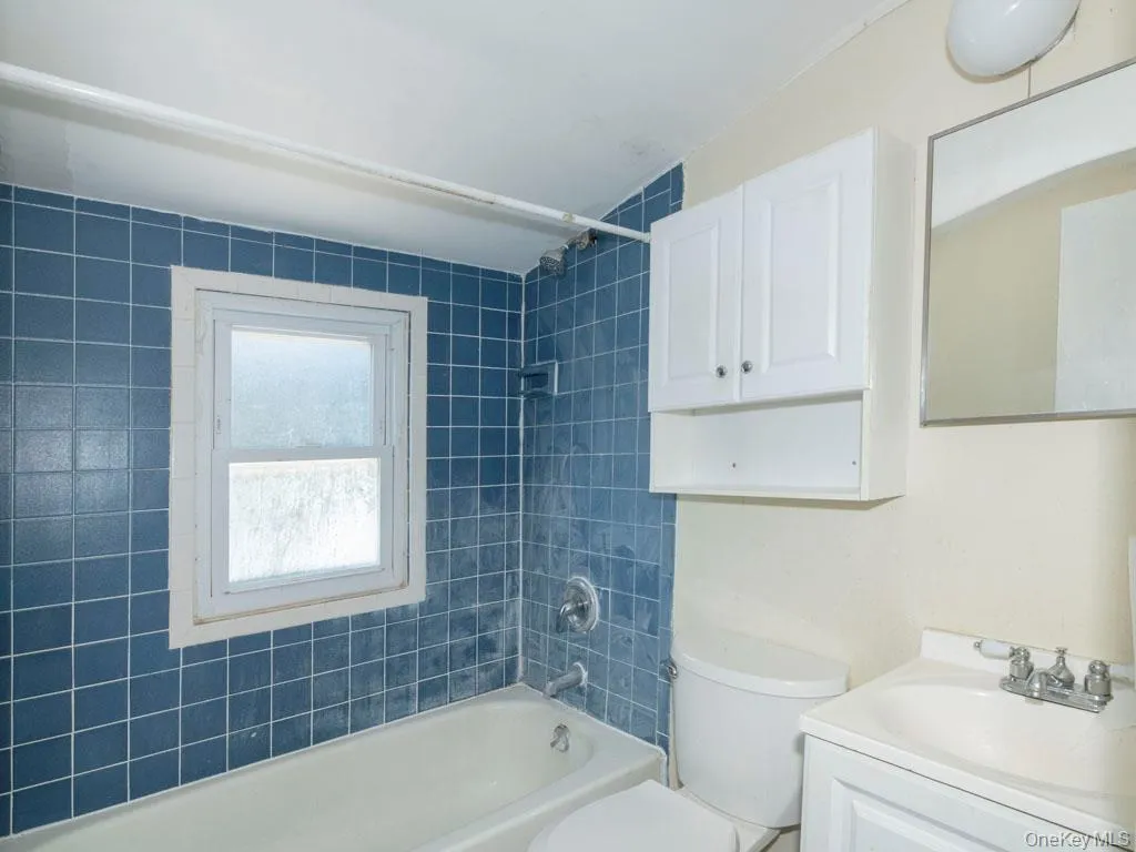 Bathroom featuring vanity and tub / shower combination Bathroom featuring vanity and tub / shower combination