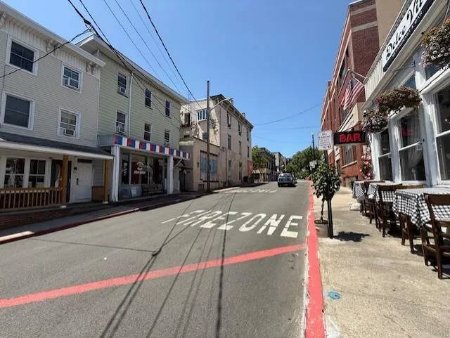 View of asphalt street featuring sidewalks and curbs View of asphalt street featuring sidewalks and curbs