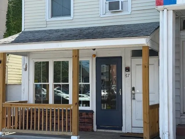 Property entrance featuring roof with shingles Property entrance featuring roof with shingles
