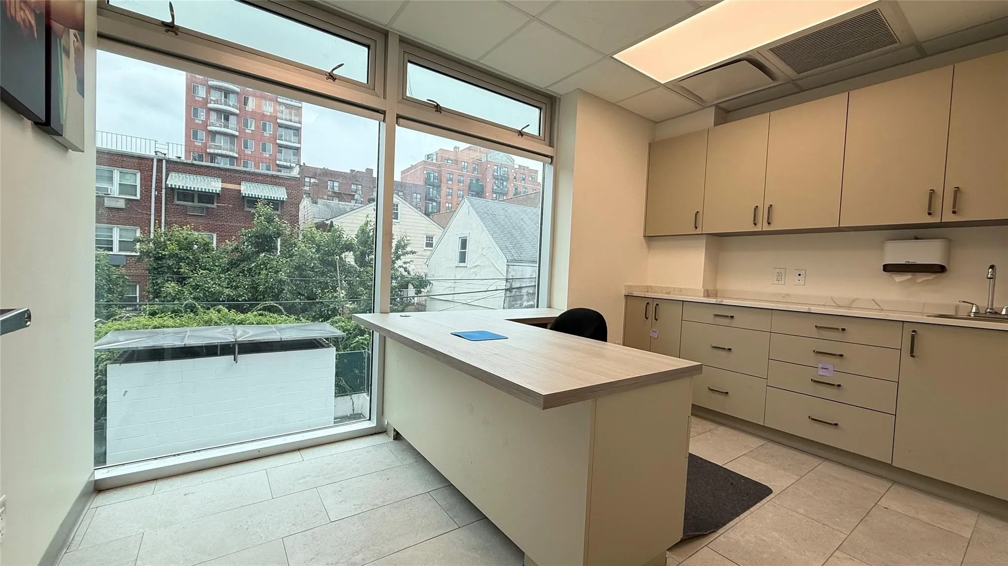 Office area featuring a sink and a city view Office area featuring a sink and a city view