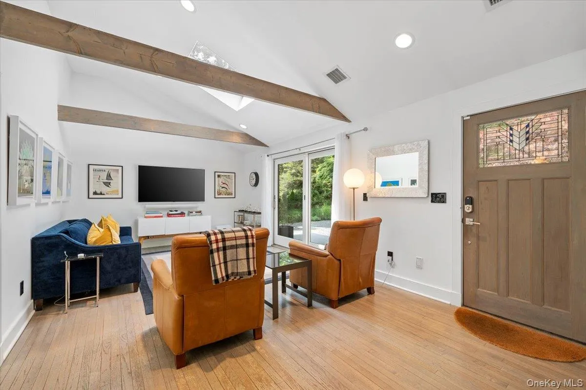 Living area with light wood finished floors, a skylight, and recessed lighting Living area with light wood finished floors, a skylight, and recessed lighting