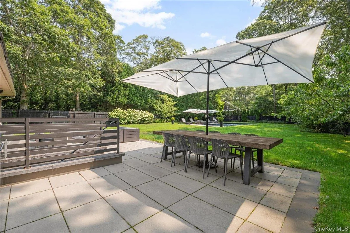 View of patio featuring outdoor dining area and view of scattered trees View of patio featuring outdoor dining area and view of scattered trees