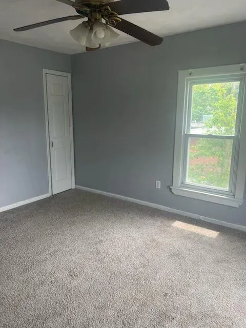 Empty room with ceiling fan and carpet Empty room with ceiling fan and carpet