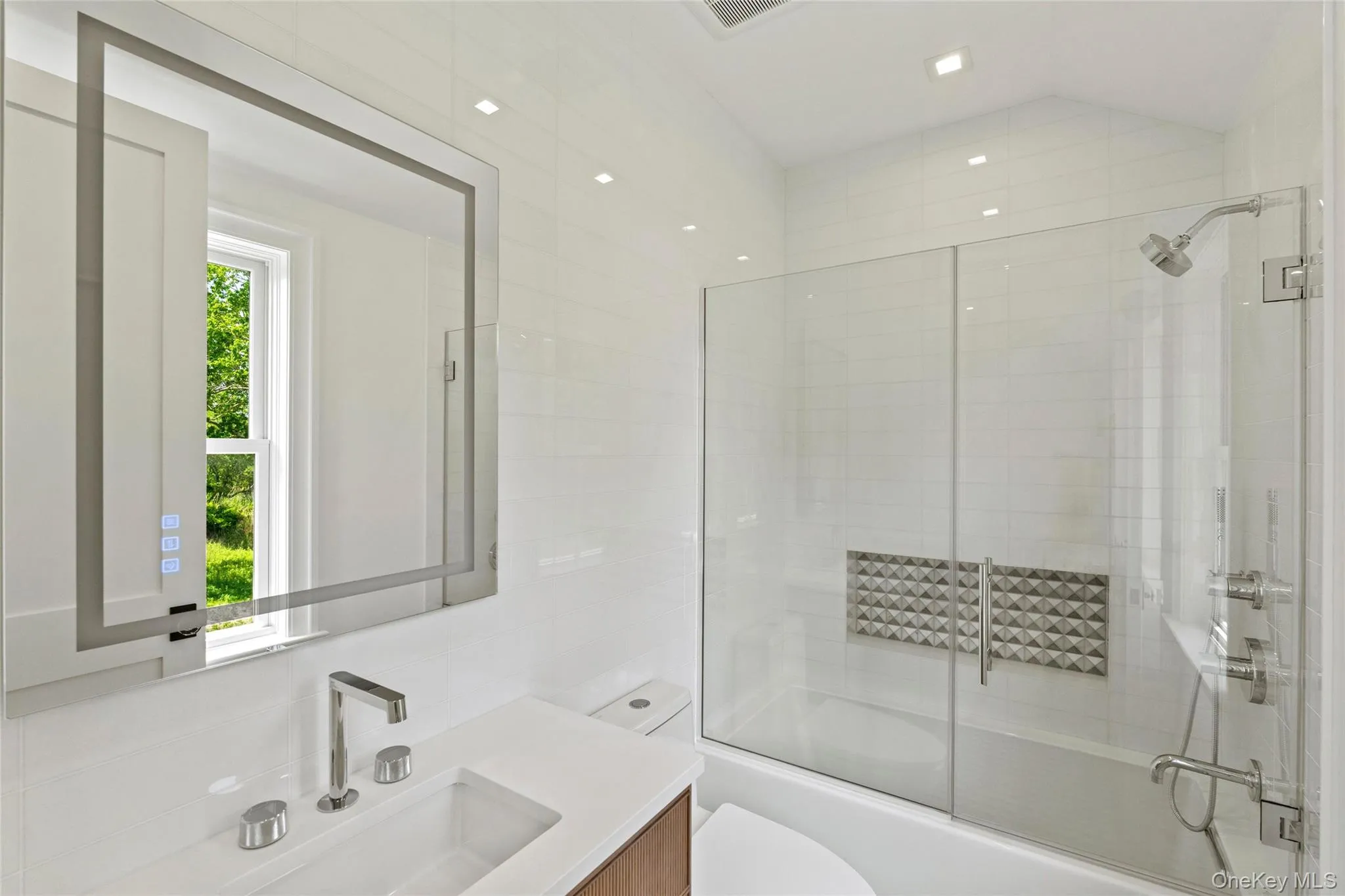 Bathroom featuring vanity and combined bath / shower with glass door Bathroom featuring vanity and combined bath / shower with glass door