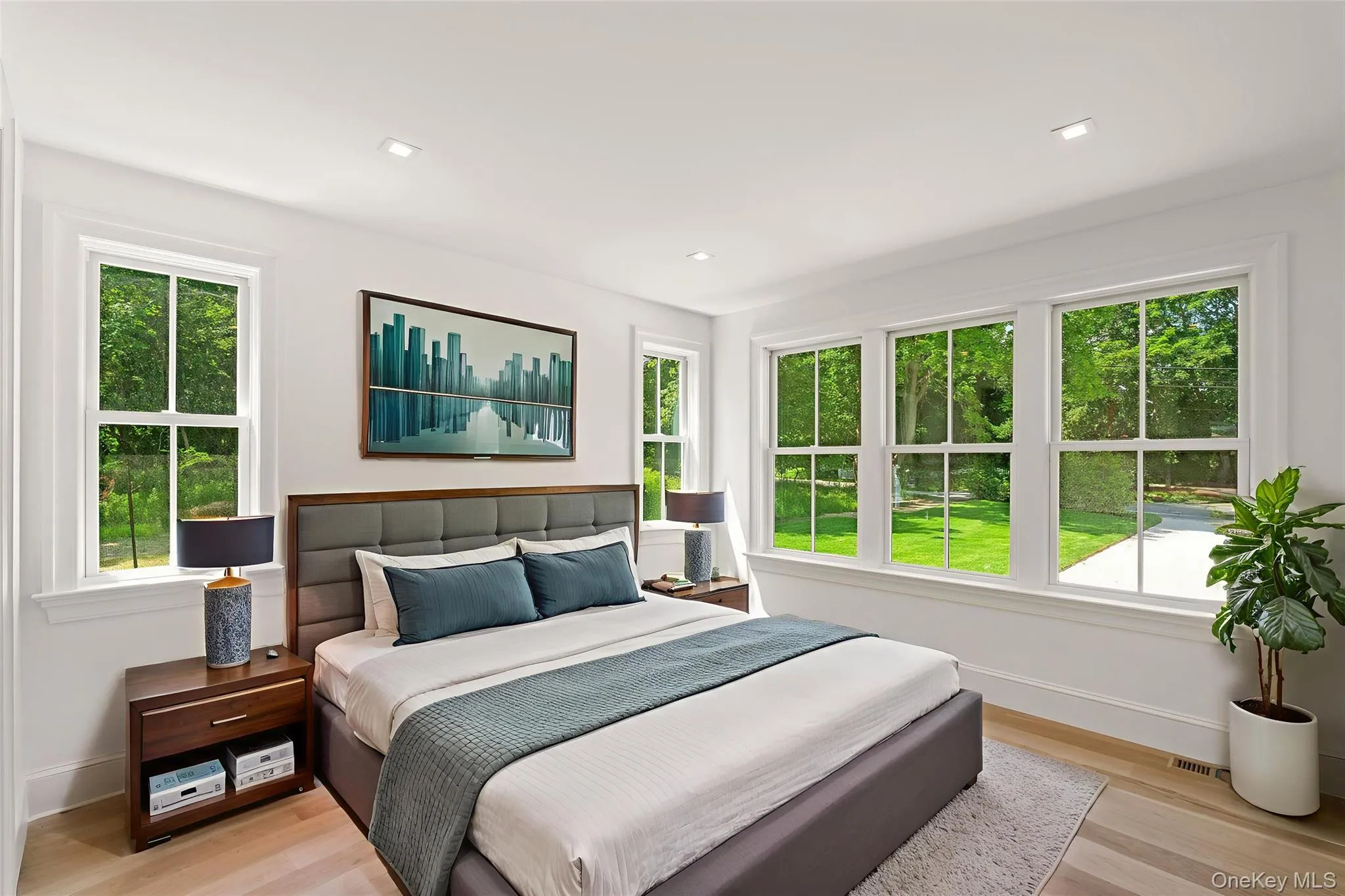 Spacious 1st Floor Guest Bedroom with multiple windows and light wood-style flooring Spacious 1st Floor Guest Bedroom with multiple windows and light wood-style flooring