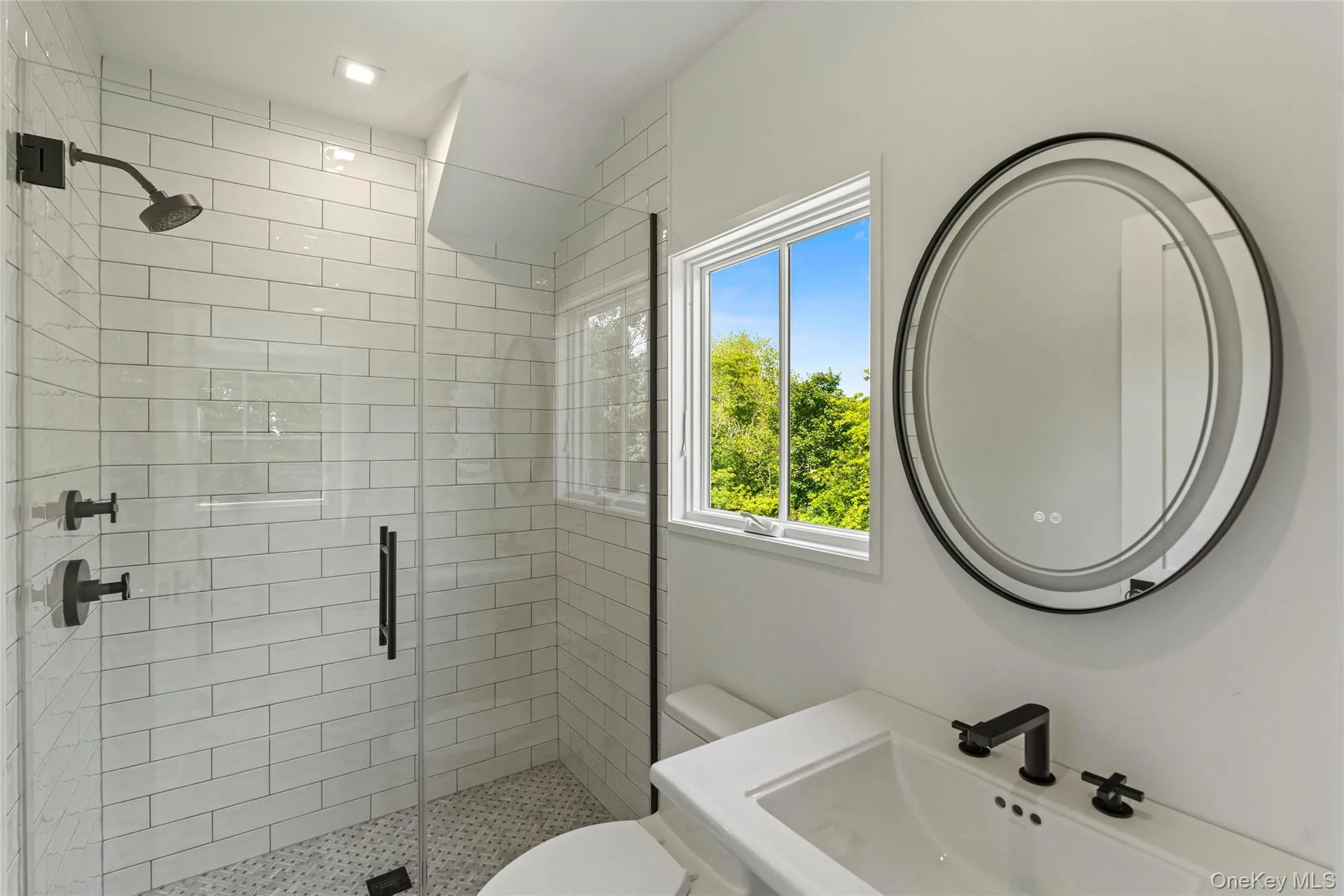 Full bath featuring a sink and a shower stall Full bath featuring a sink and a shower stall
