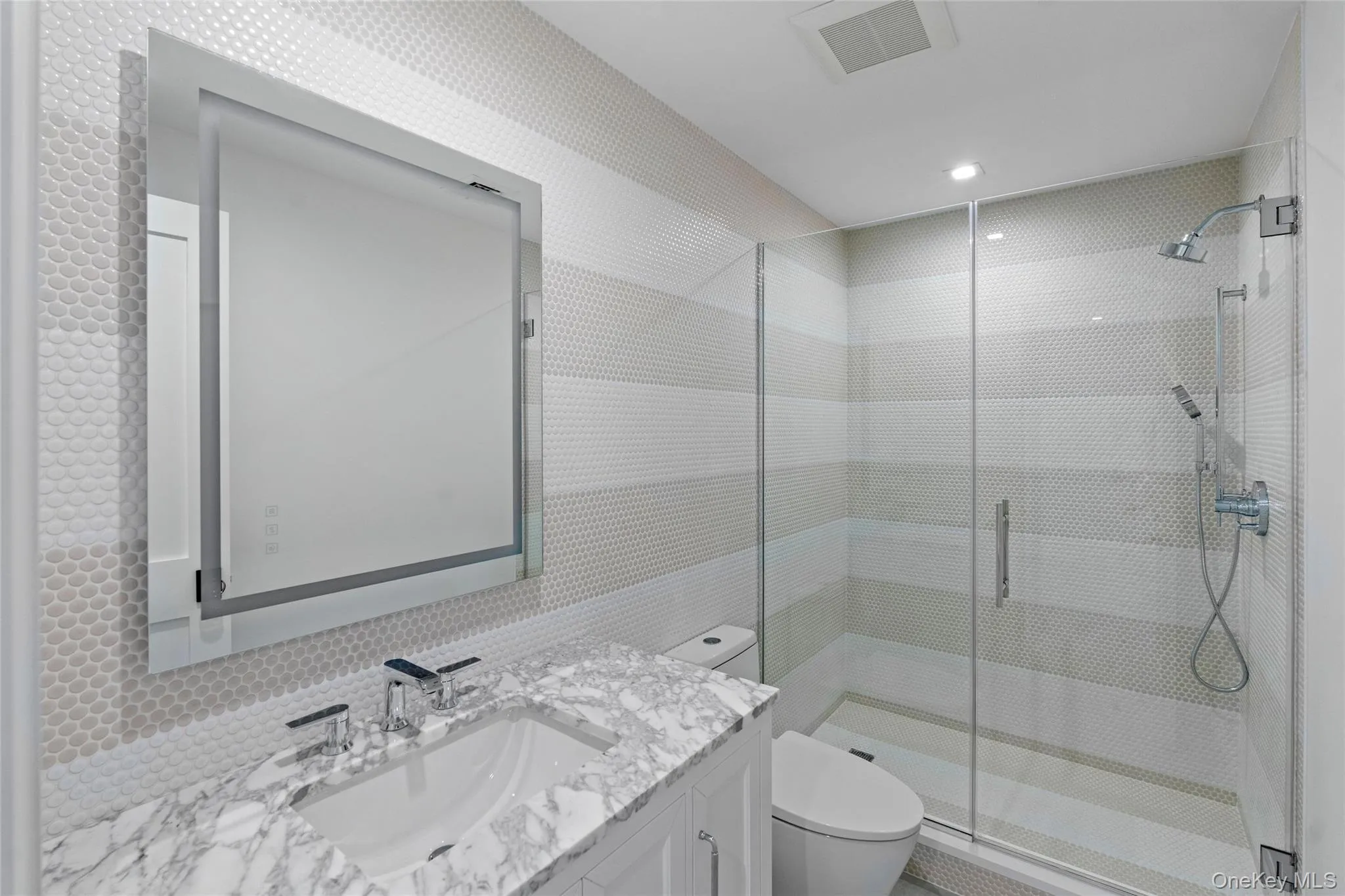 Full bath featuring vanity, a shower stall, recessed lighting, and backsplash Full bath featuring vanity, a shower stall, recessed lighting, and backsplash