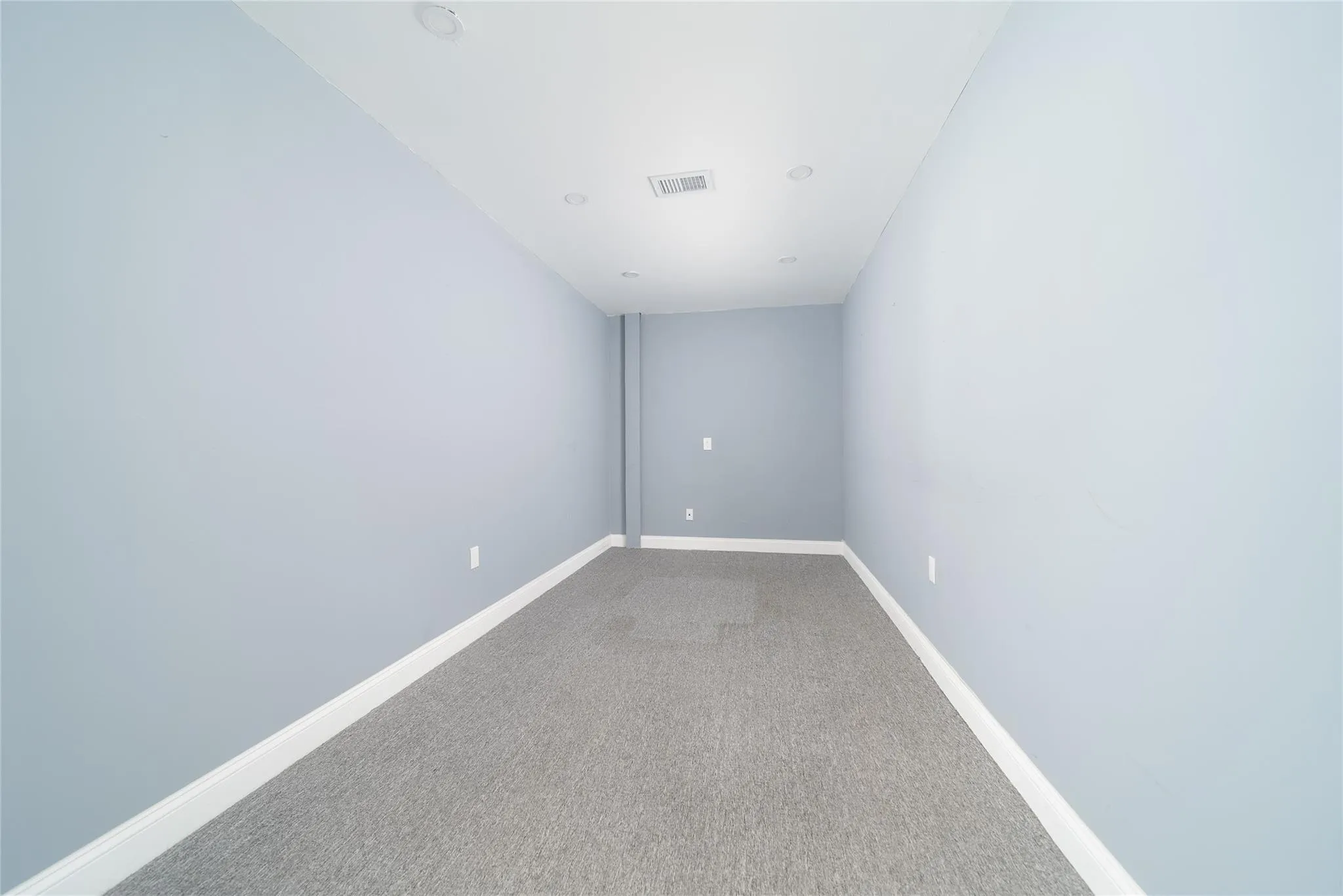 Empty room with light carpet and baseboards Empty room with light carpet and baseboards