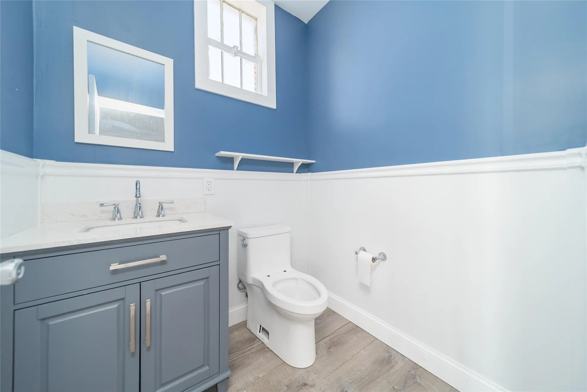 Bathroom with vanity and wood finished floors Bathroom with vanity and wood finished floors