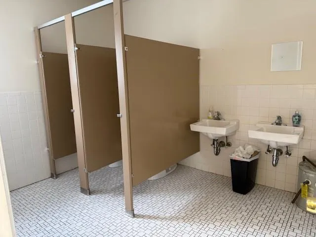 Bathroom with tile walls, a wainscoted wall, and tile patterned floors Bathroom with tile walls, a wainscoted wall, and tile patterned floors
